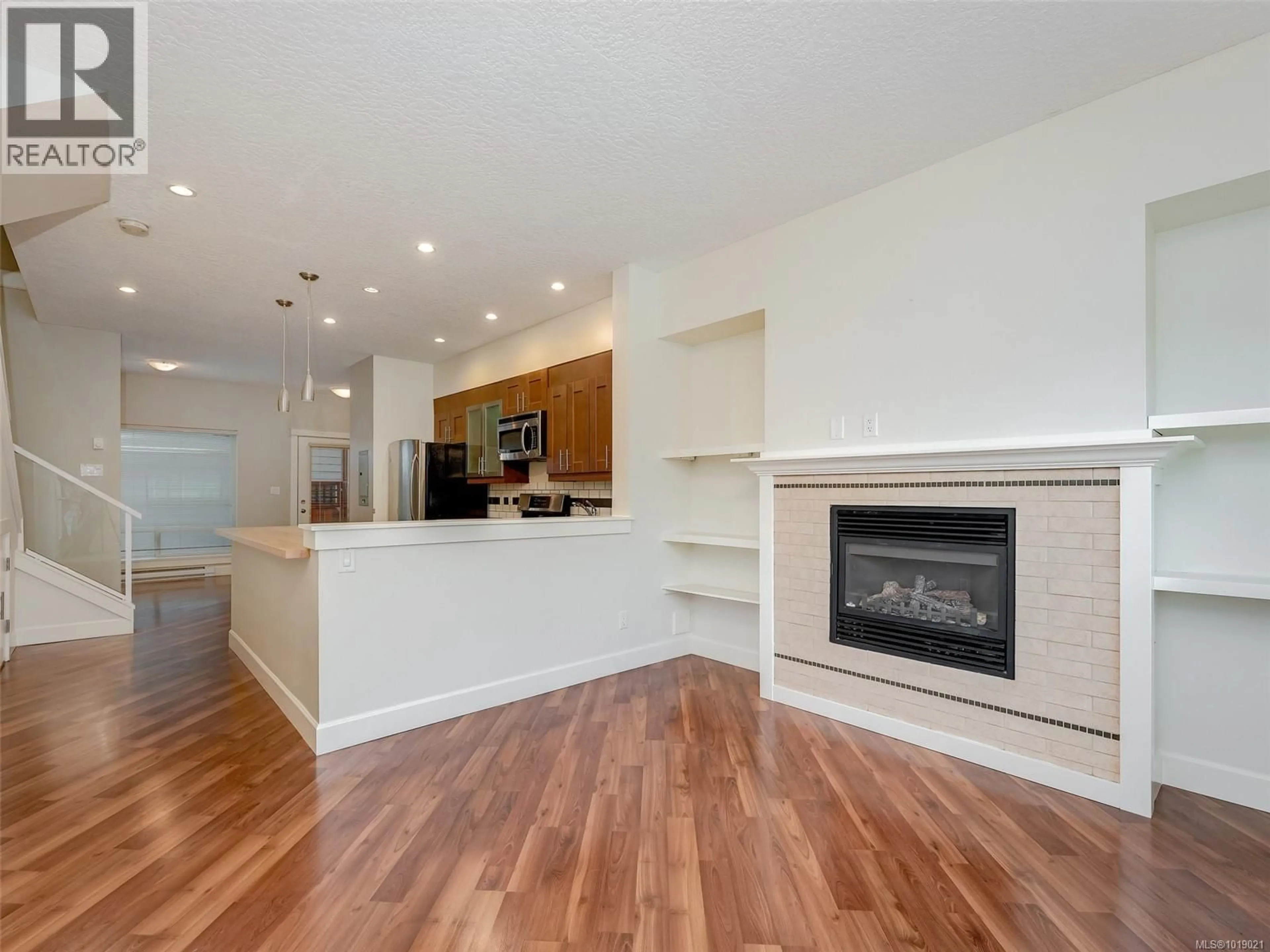 Open concept kitchen, wood/laminate floor for 201 - 785 STATION AVENUE, Langford British Columbia V9B0E6