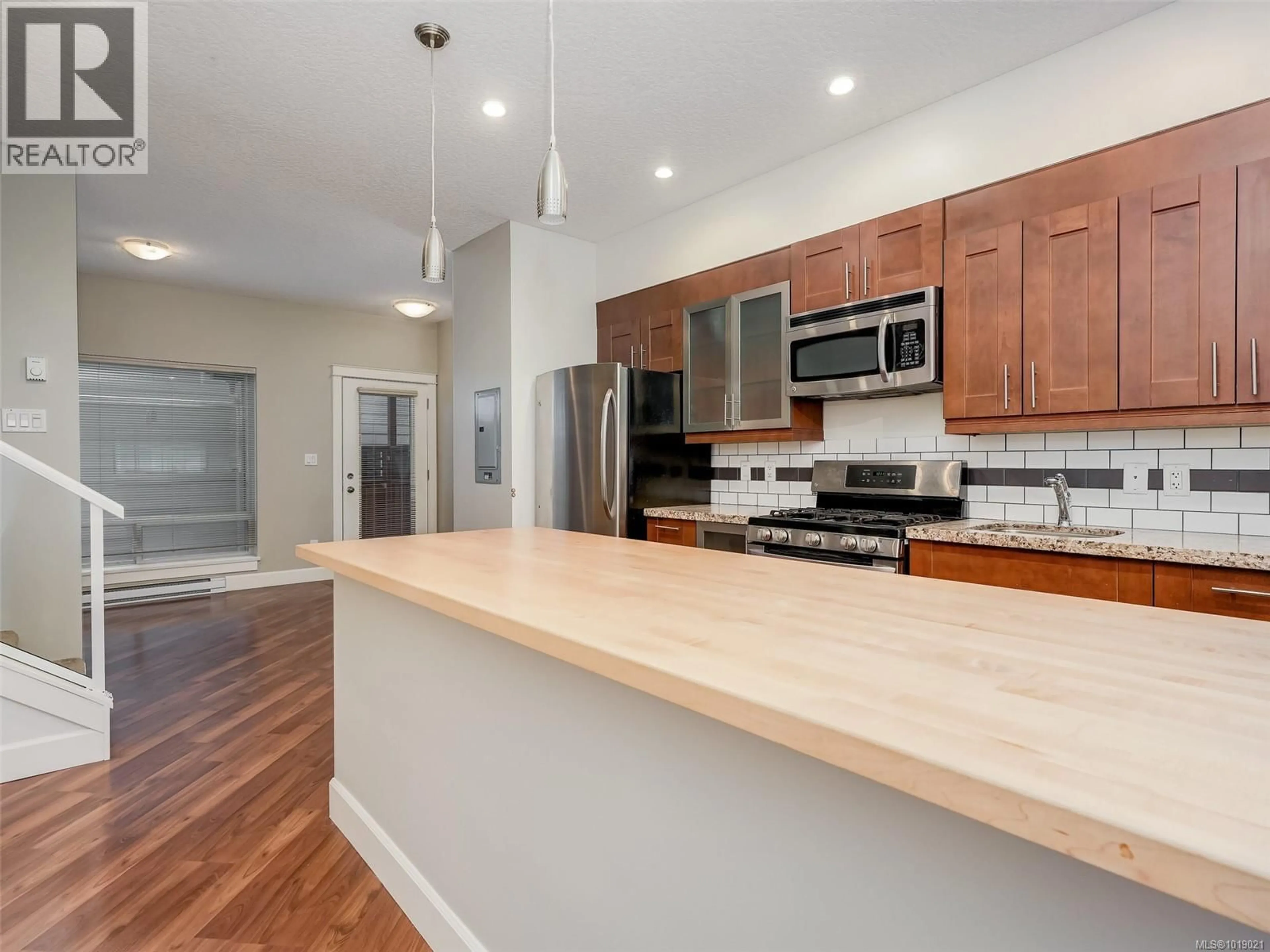 Open concept kitchen, wood/laminate floor for 201 - 785 STATION AVENUE, Langford British Columbia V9B0E6