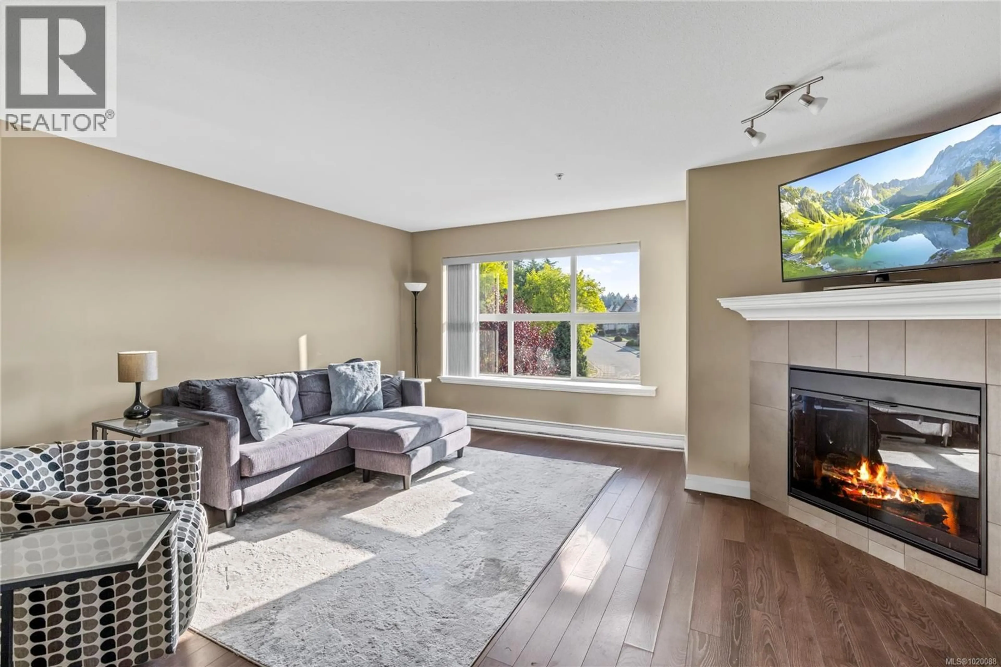 Living room with furniture, wood/laminate floor for 201 - 5945 KADEN PLACE, Nanaimo British Columbia V9T0B5
