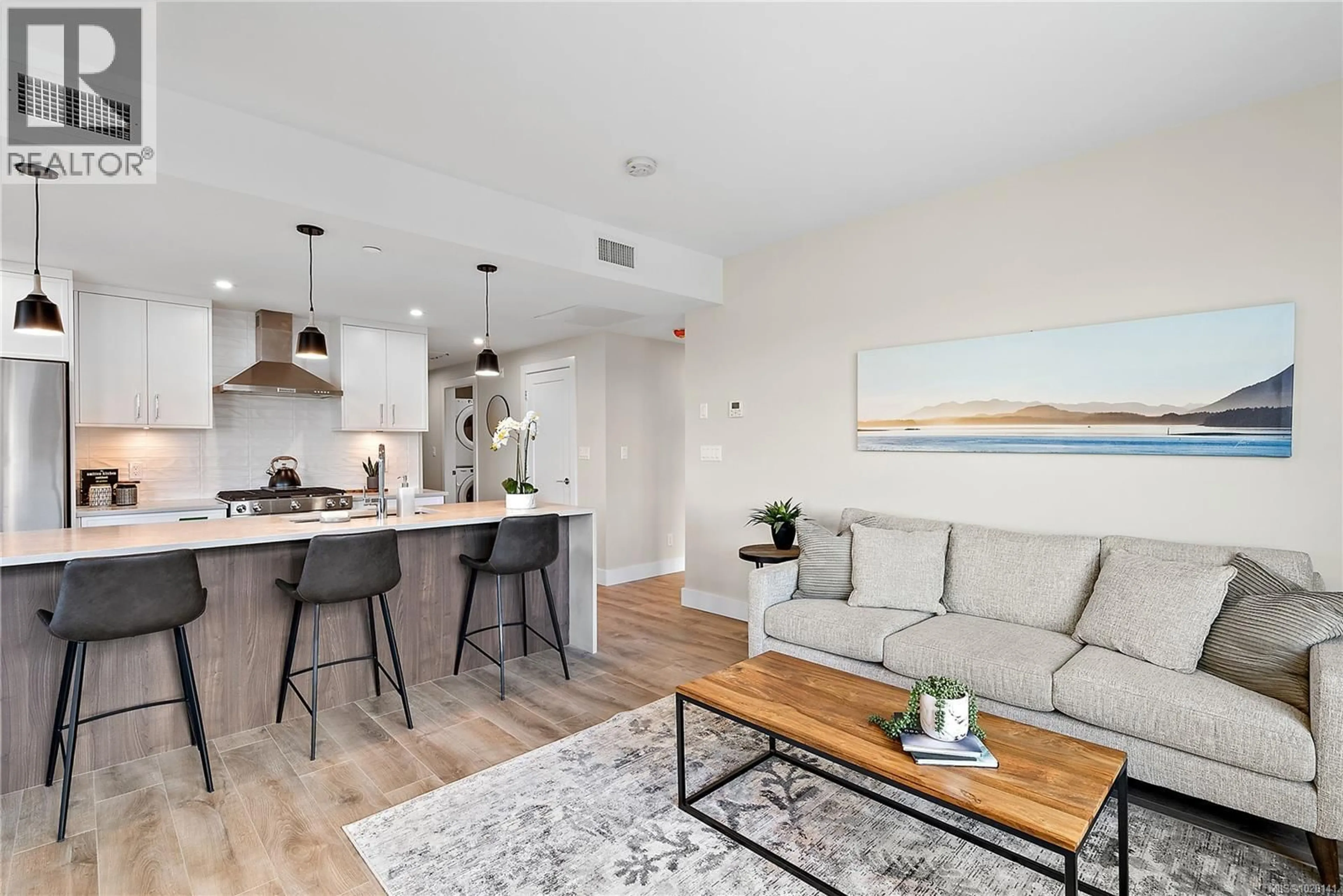 Open concept kitchen, wood/laminate floor for 208 - 2520 HACKETT CRESCENT, Central Saanich British Columbia V8M0B9