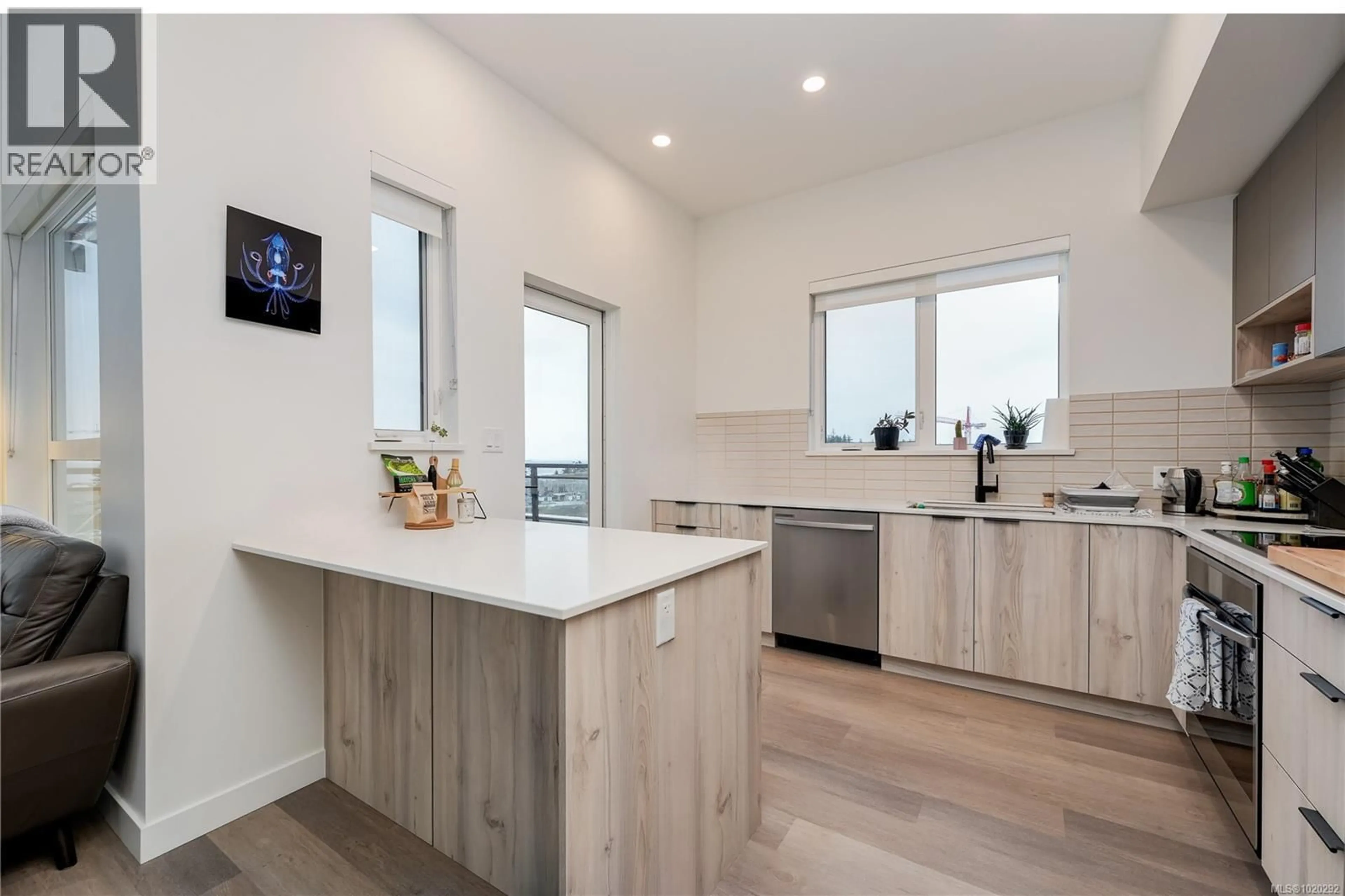 Open concept kitchen, wood/laminate floor for 413 - 3564B RYDER HESJEDAL WAY, Colwood British Columbia V9C3A1