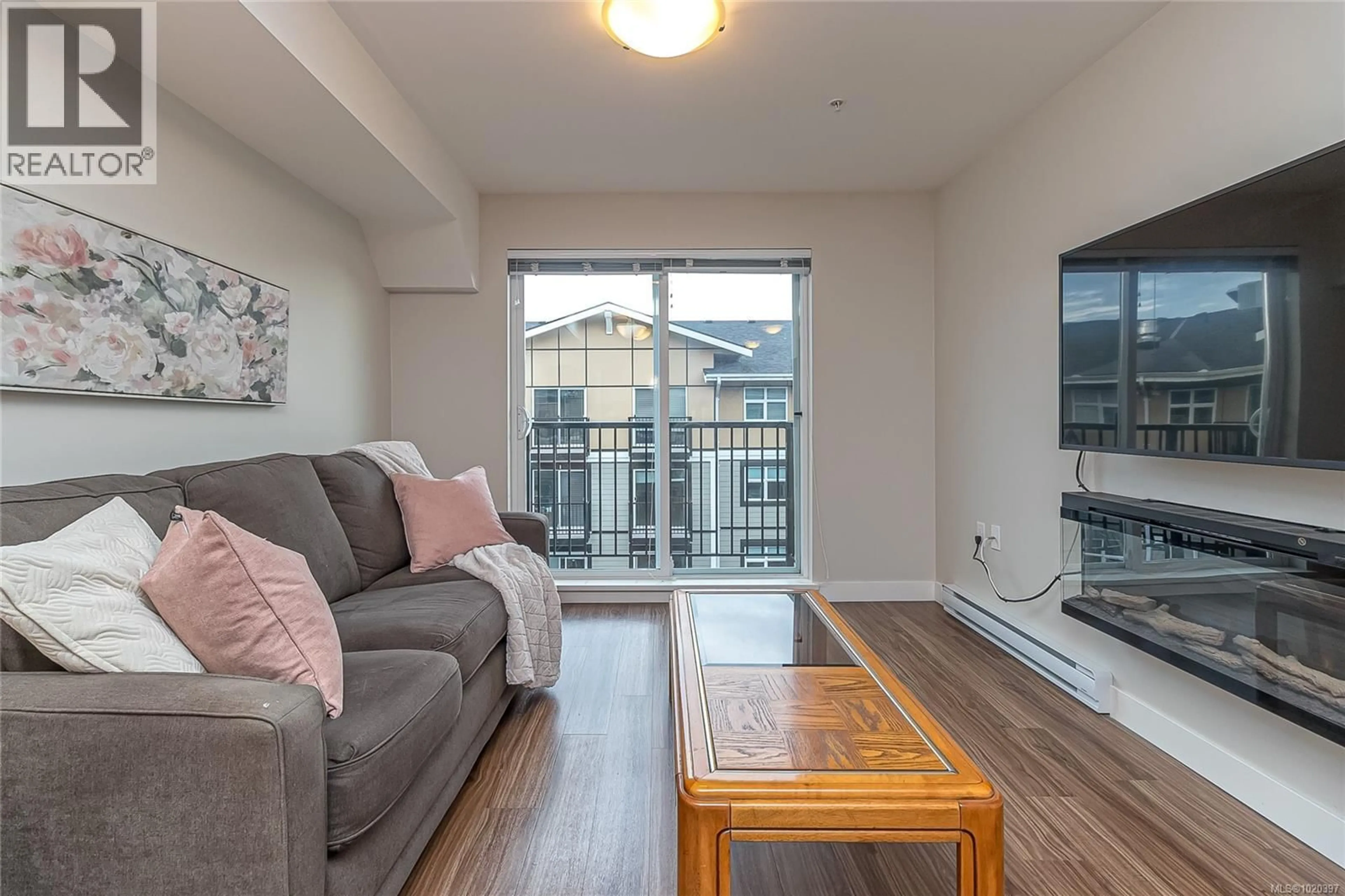Living room with furniture, wood/laminate floor for 606 - 917 AVRILL ROAD, Langford British Columbia V9B0T2