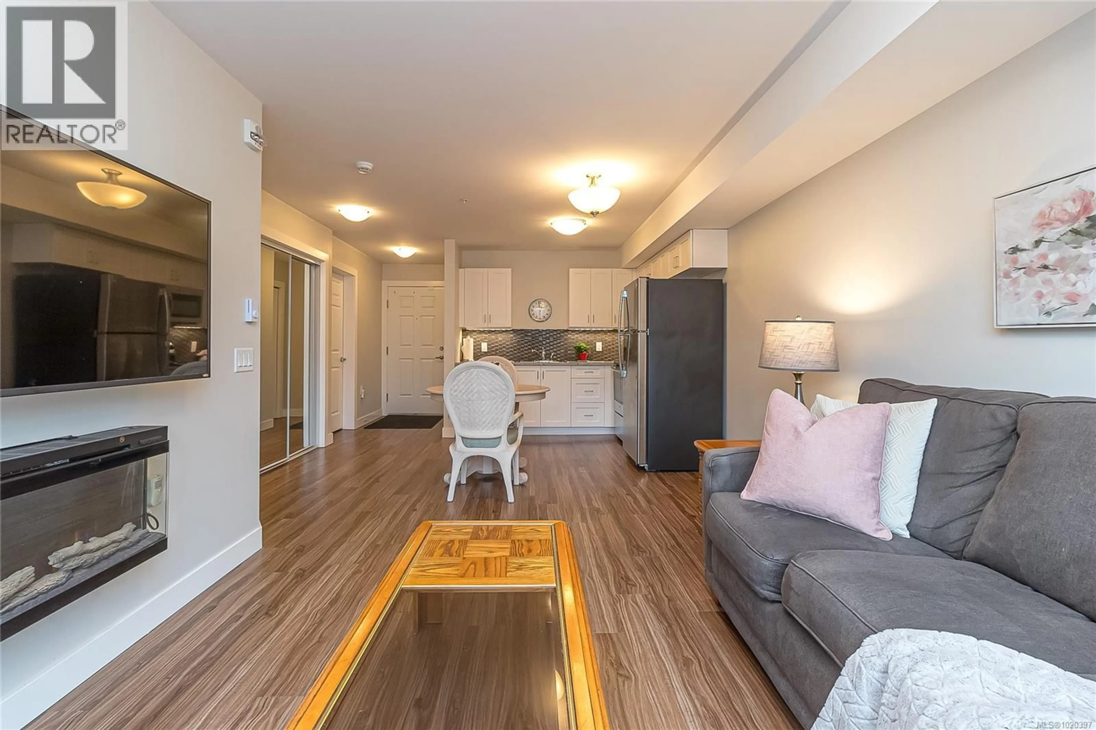 Living room with furniture, wood/laminate floor for 606 - 917 AVRILL ROAD, Langford British Columbia V9B0T2