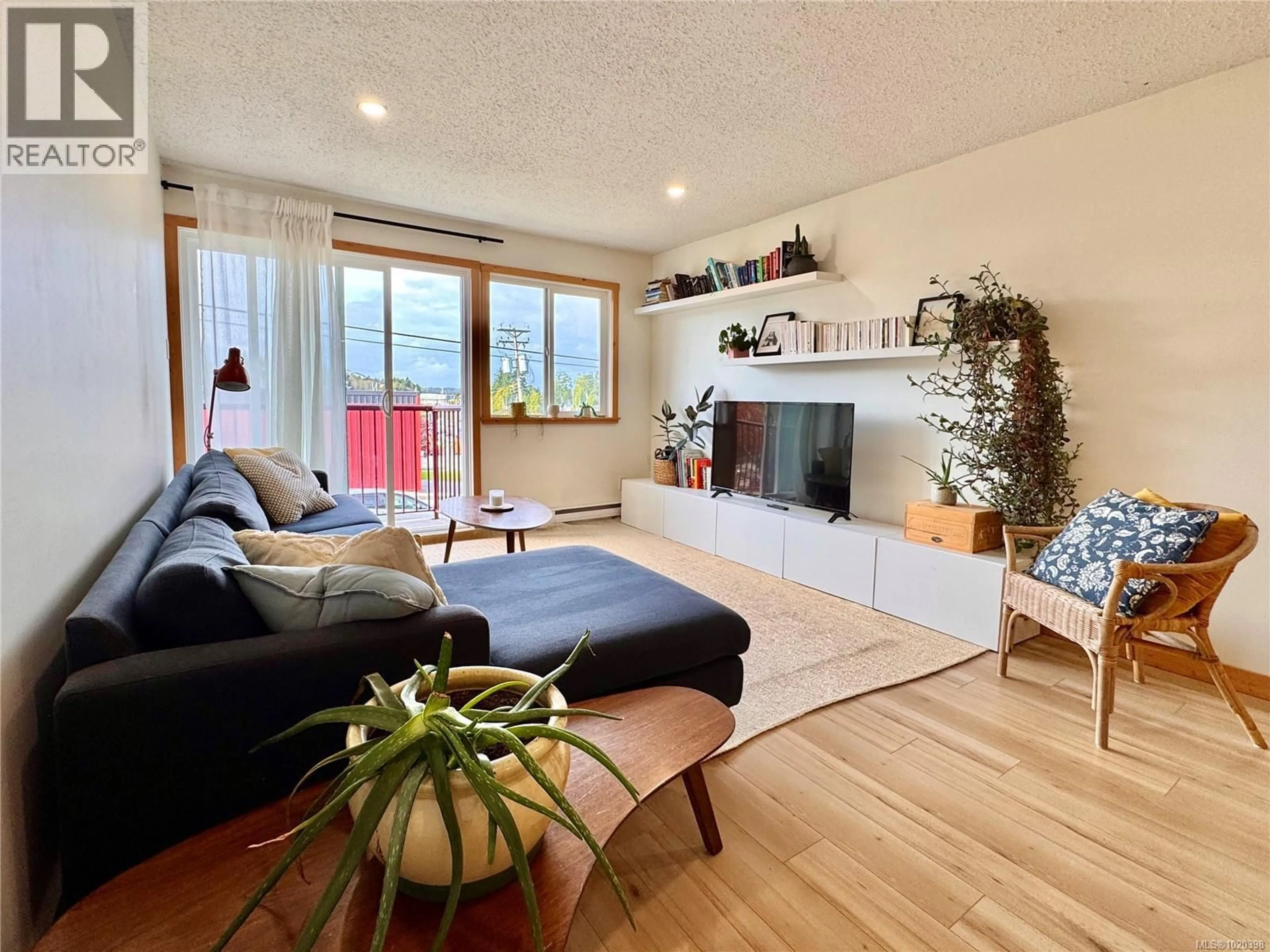 Living room with furniture, wood/laminate floor for 203 - 250 HEMLOCK STREET, Ucluelet British Columbia V0R3A0