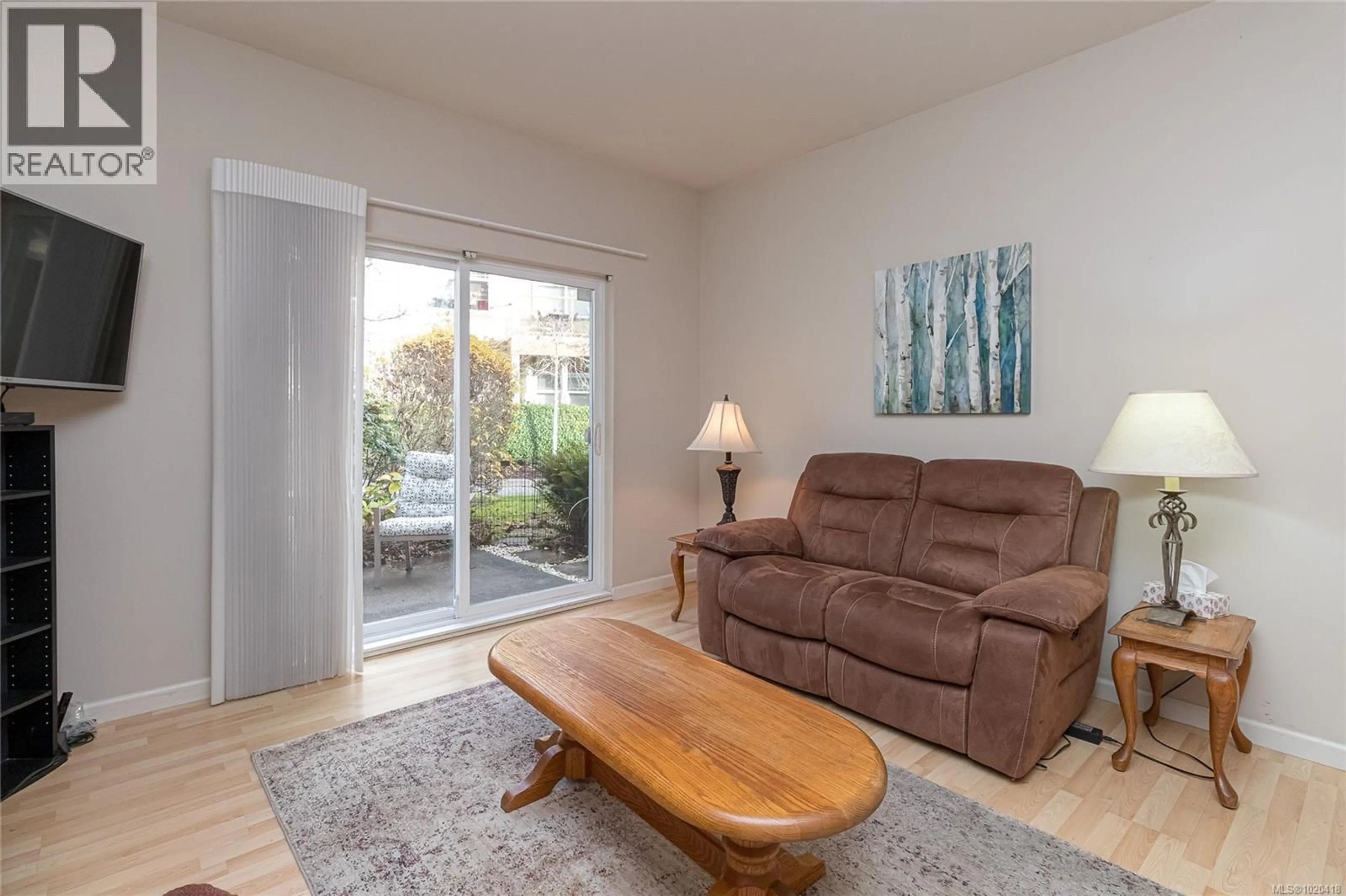 Living room with furniture, wood/laminate floor for 1954 POLO PARK COURT, Central Saanich British Columbia V8M2K1