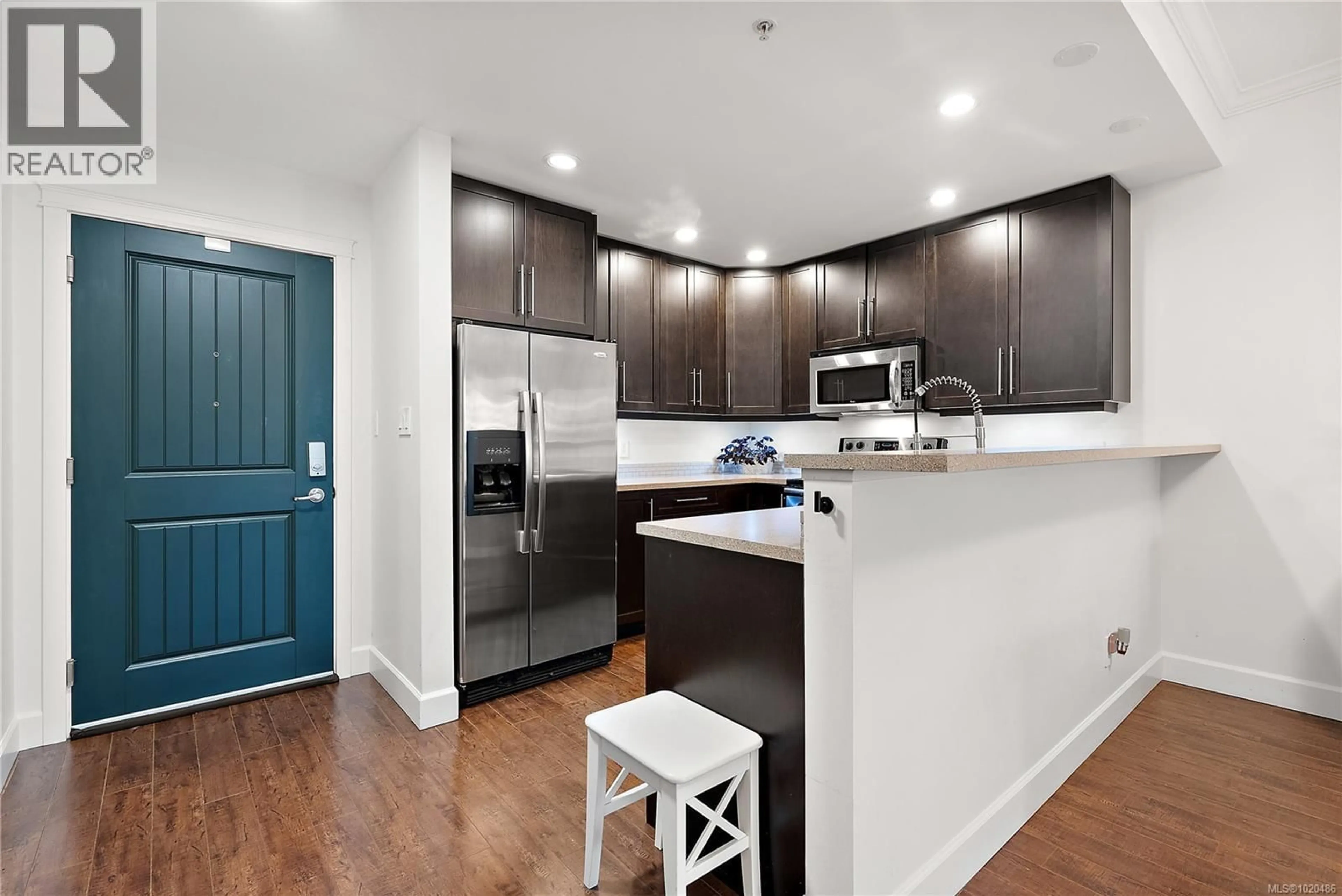 Open concept kitchen, wood/laminate floor for 407 - 2881 PEATT ROAD, Langford British Columbia V9B3V7