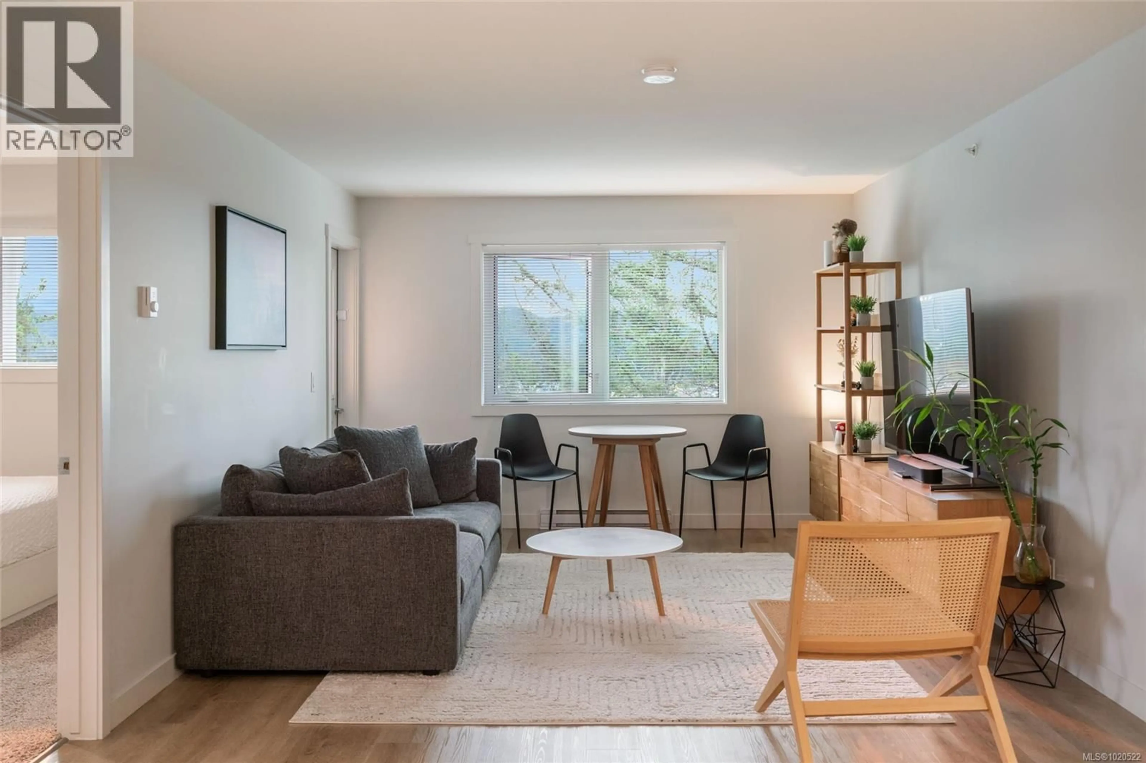 Living room with furniture, wood/laminate floor for 202 - 4820 CEDAR RIDGE PLACE, Nanaimo British Columbia V9T0M7