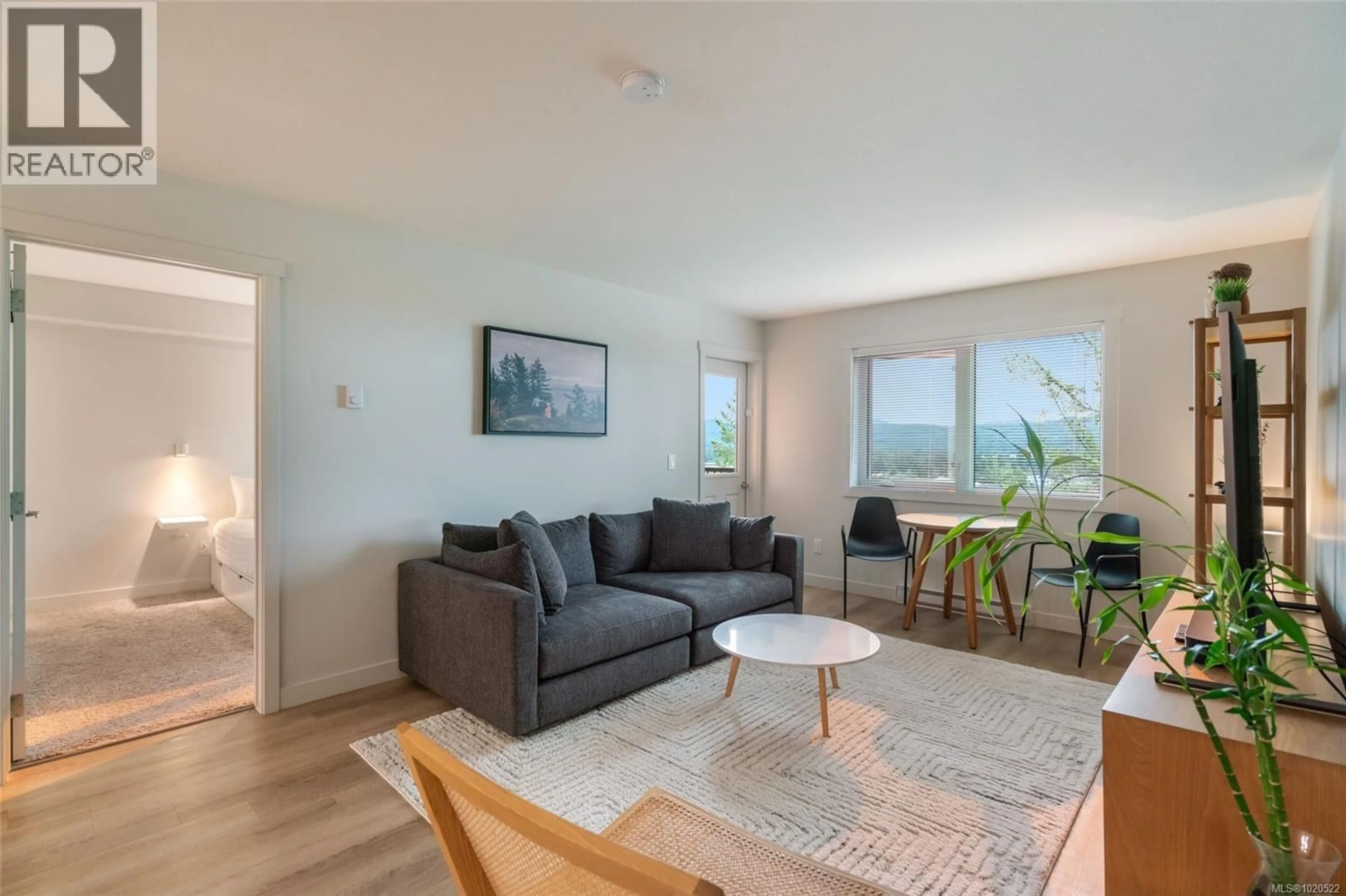 Living room with furniture, wood/laminate floor for 202 - 4820 CEDAR RIDGE PLACE, Nanaimo British Columbia V9T0M7