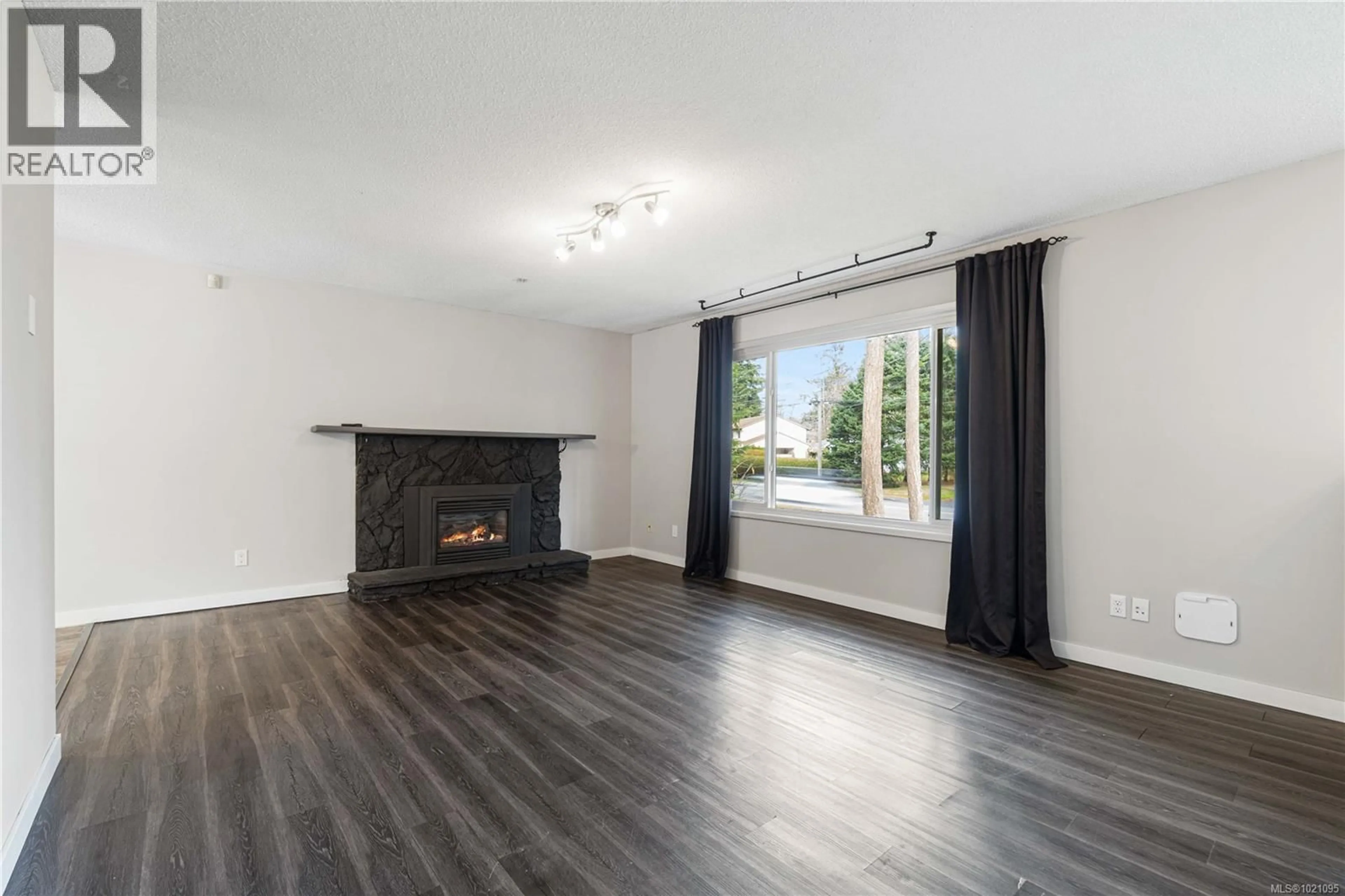 Living room with furniture, wood/laminate floor for 2675 LABIEUX ROAD, Nanaimo British Columbia V9T3N3