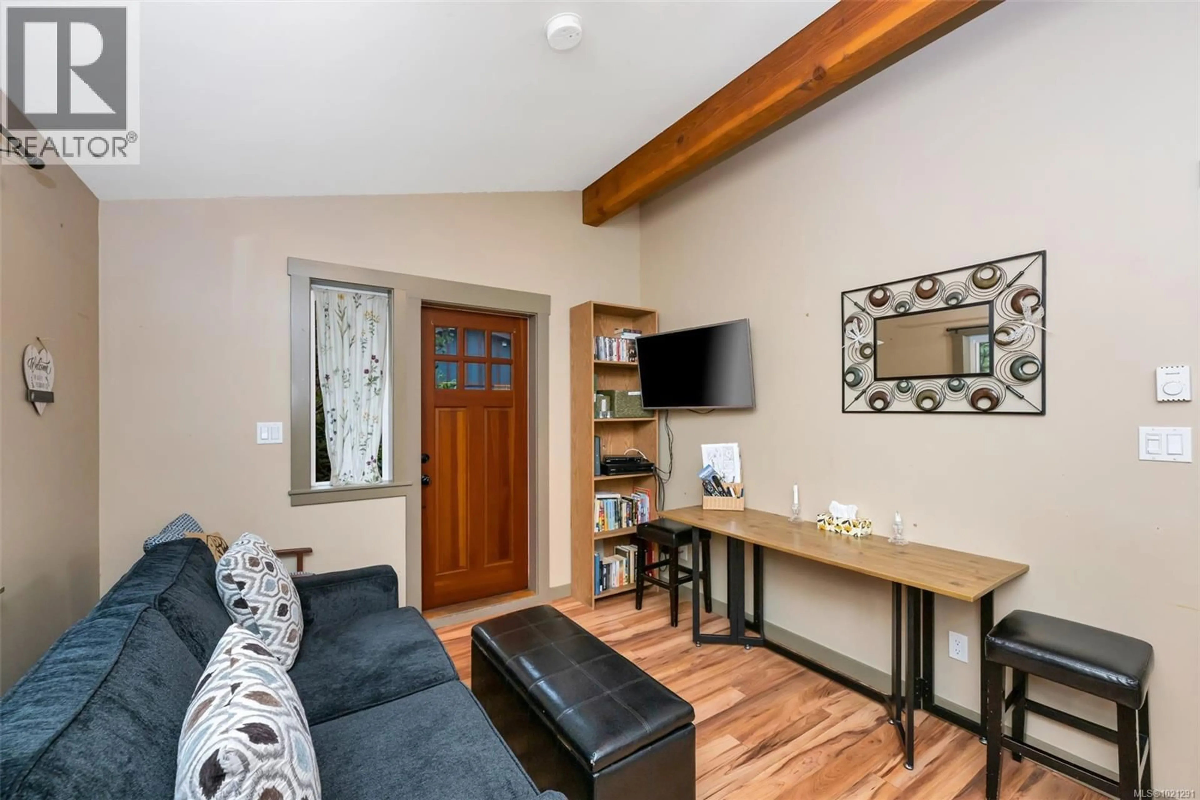 Living room with furniture, wood/laminate floor for 10 - 6574 BAIRD ROAD, Port Renfrew British Columbia V0S1K0