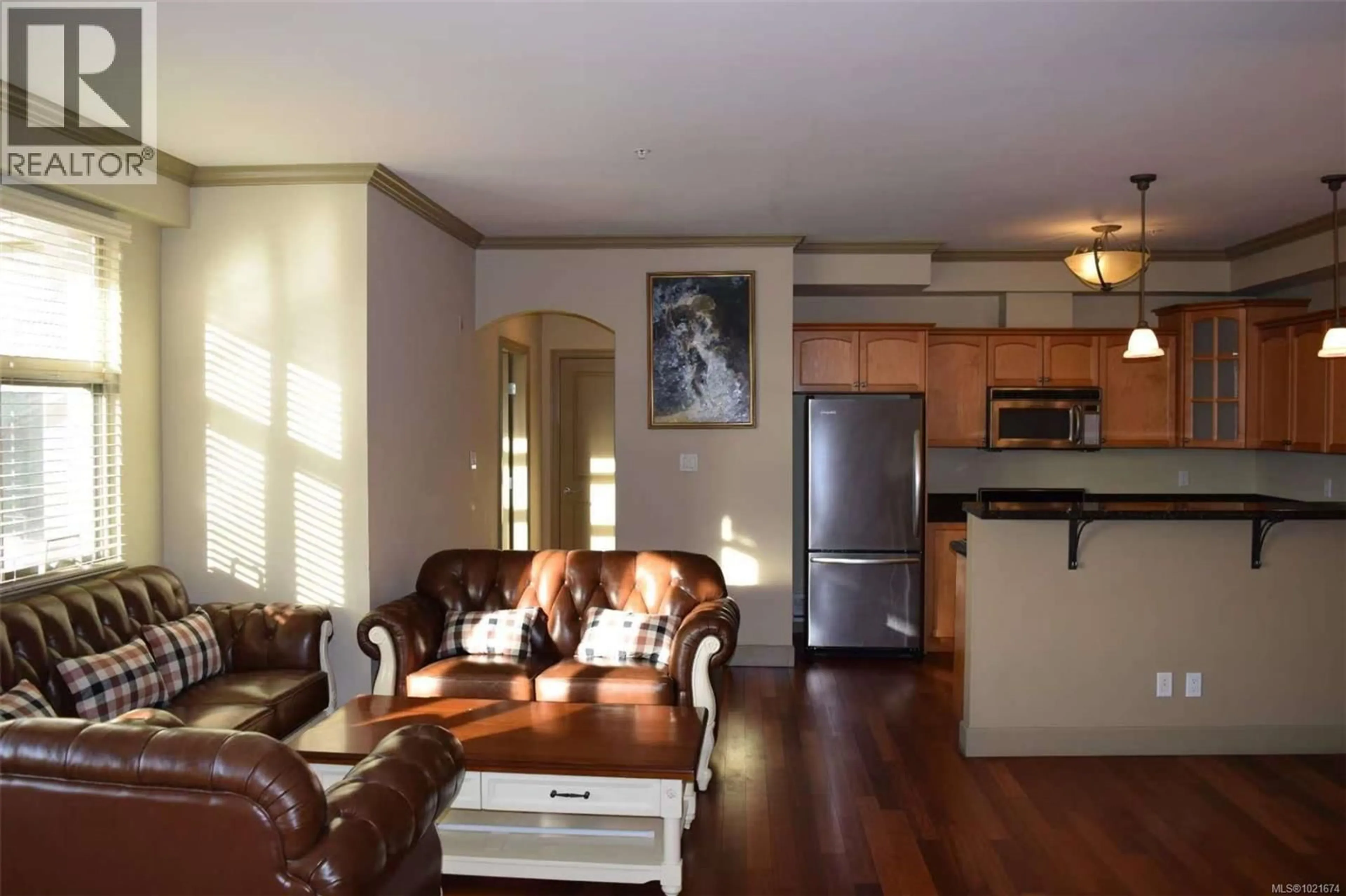 Living room with furniture, wood/laminate floor for 309 - 1620 MCKENZIE AVENUE, Saanich British Columbia V8N0A1