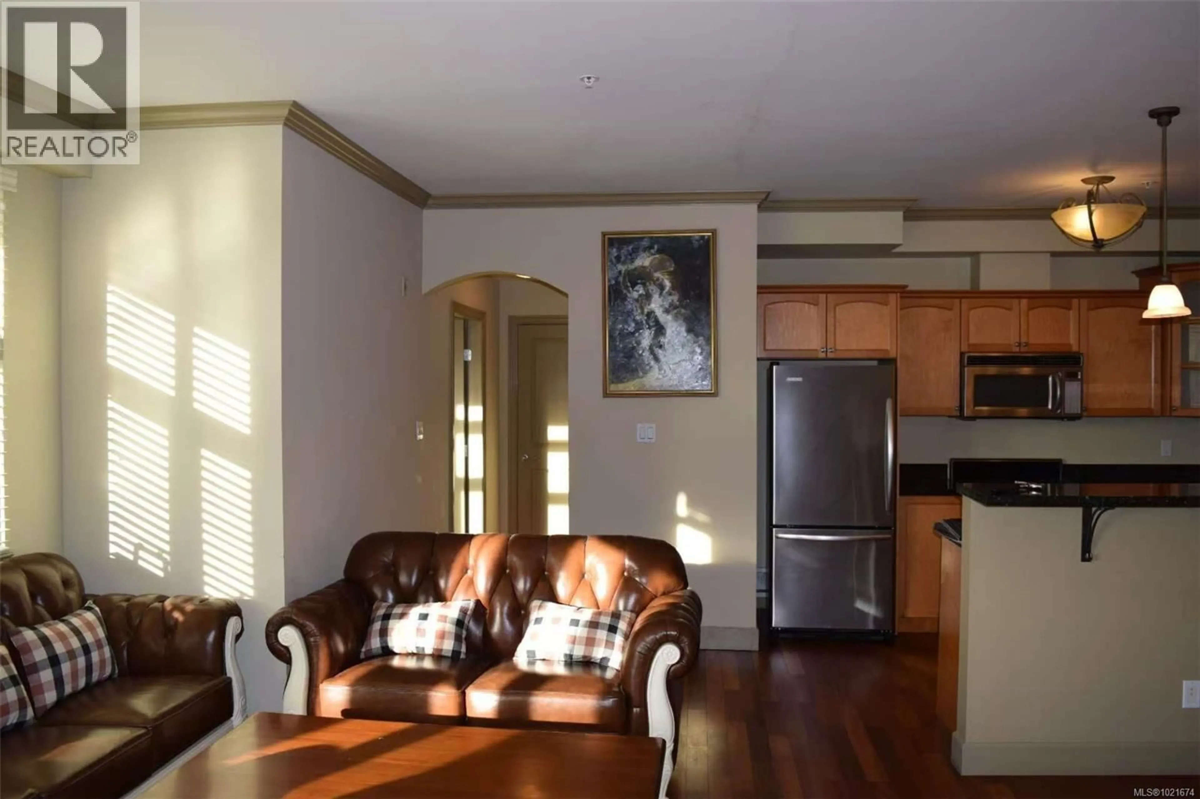 Living room with furniture, wood/laminate floor for 309 - 1620 MCKENZIE AVENUE, Saanich British Columbia V8N0A1