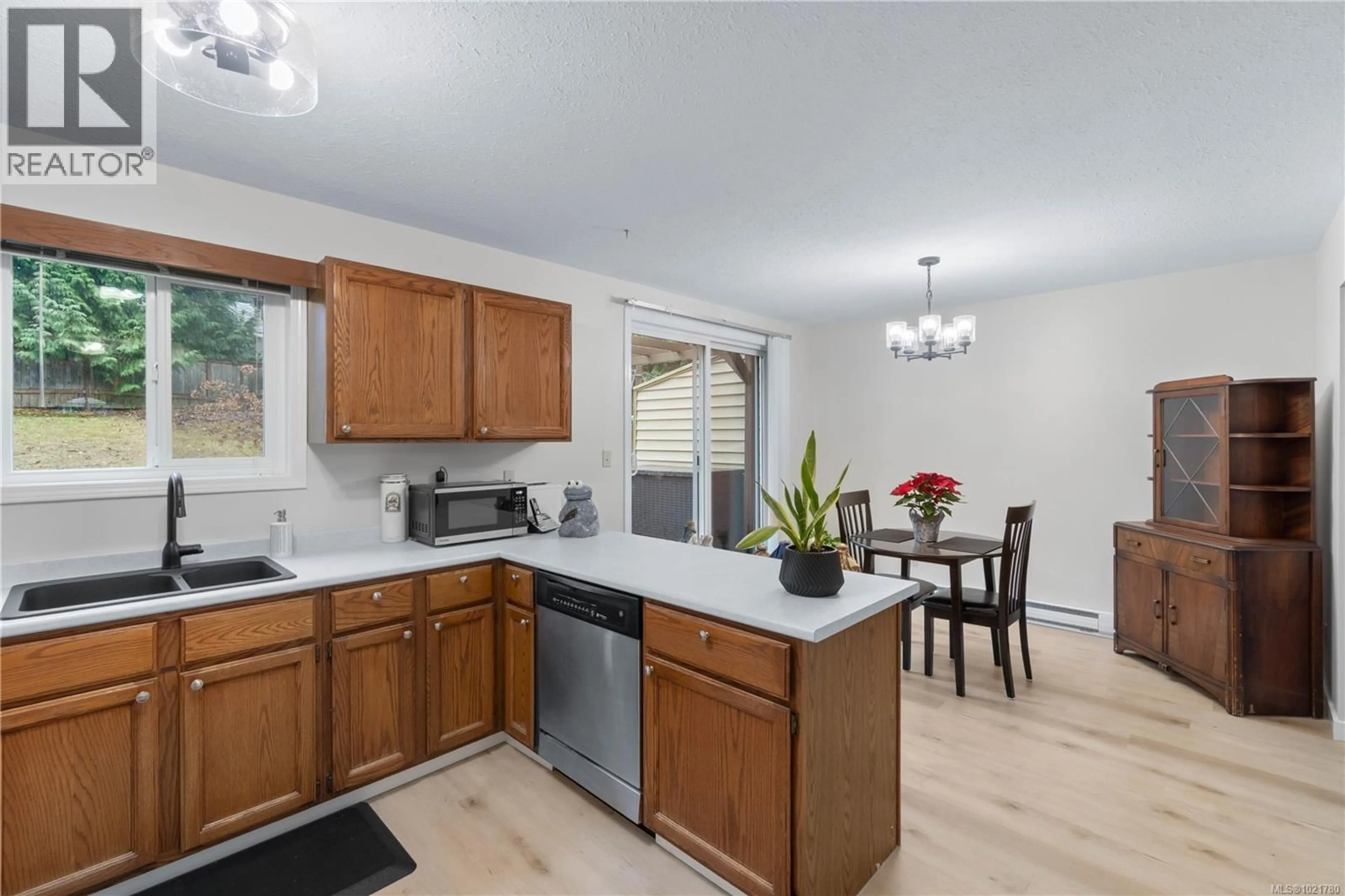 Open concept kitchen, wood/laminate floor for 2629 LABIEUX ROAD, Nanaimo British Columbia V9T3N3