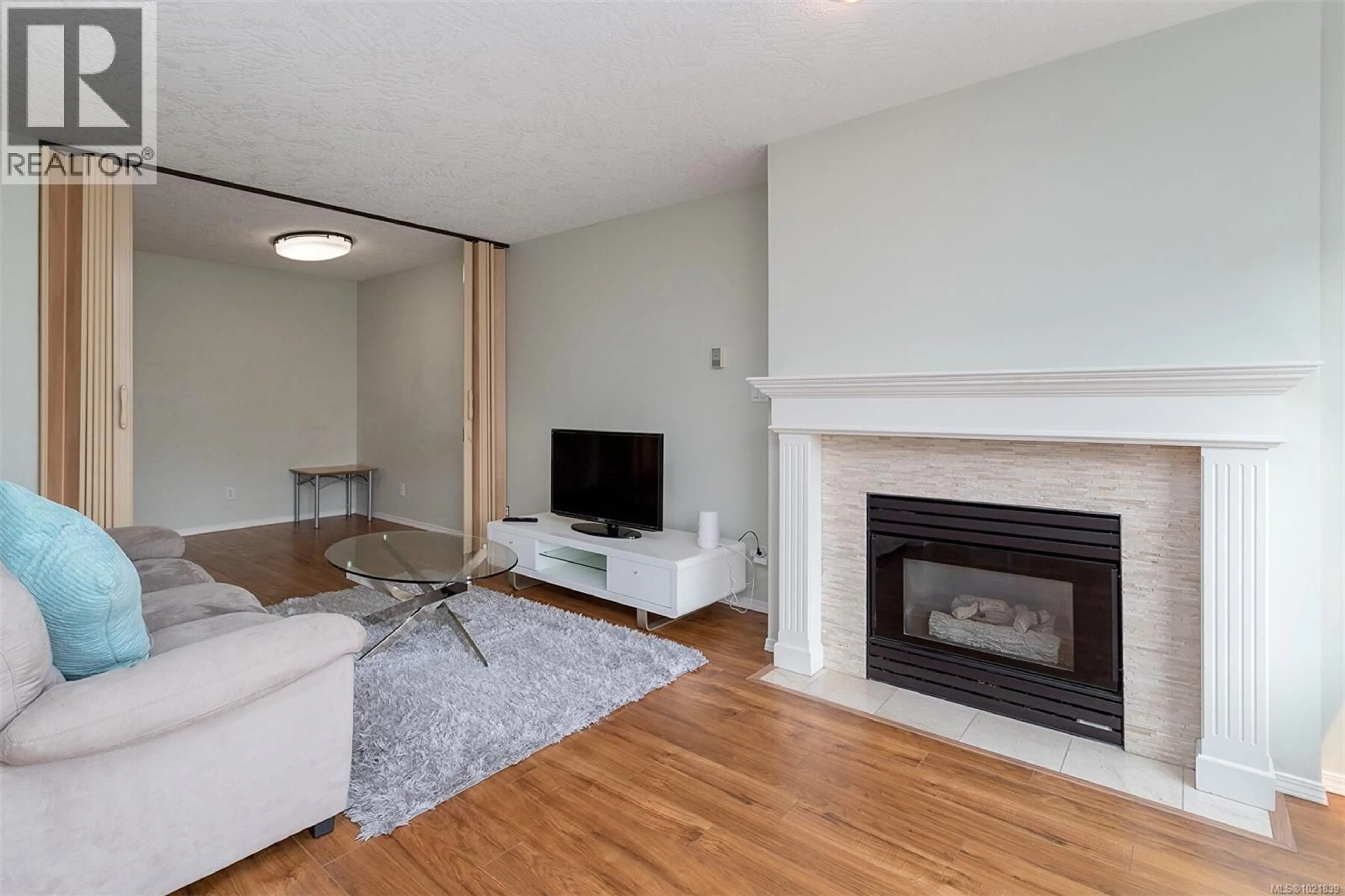 Living room with furniture, wood/laminate floor for 405 - 898 VERNON AVENUE, Saanich British Columbia V8X2W6