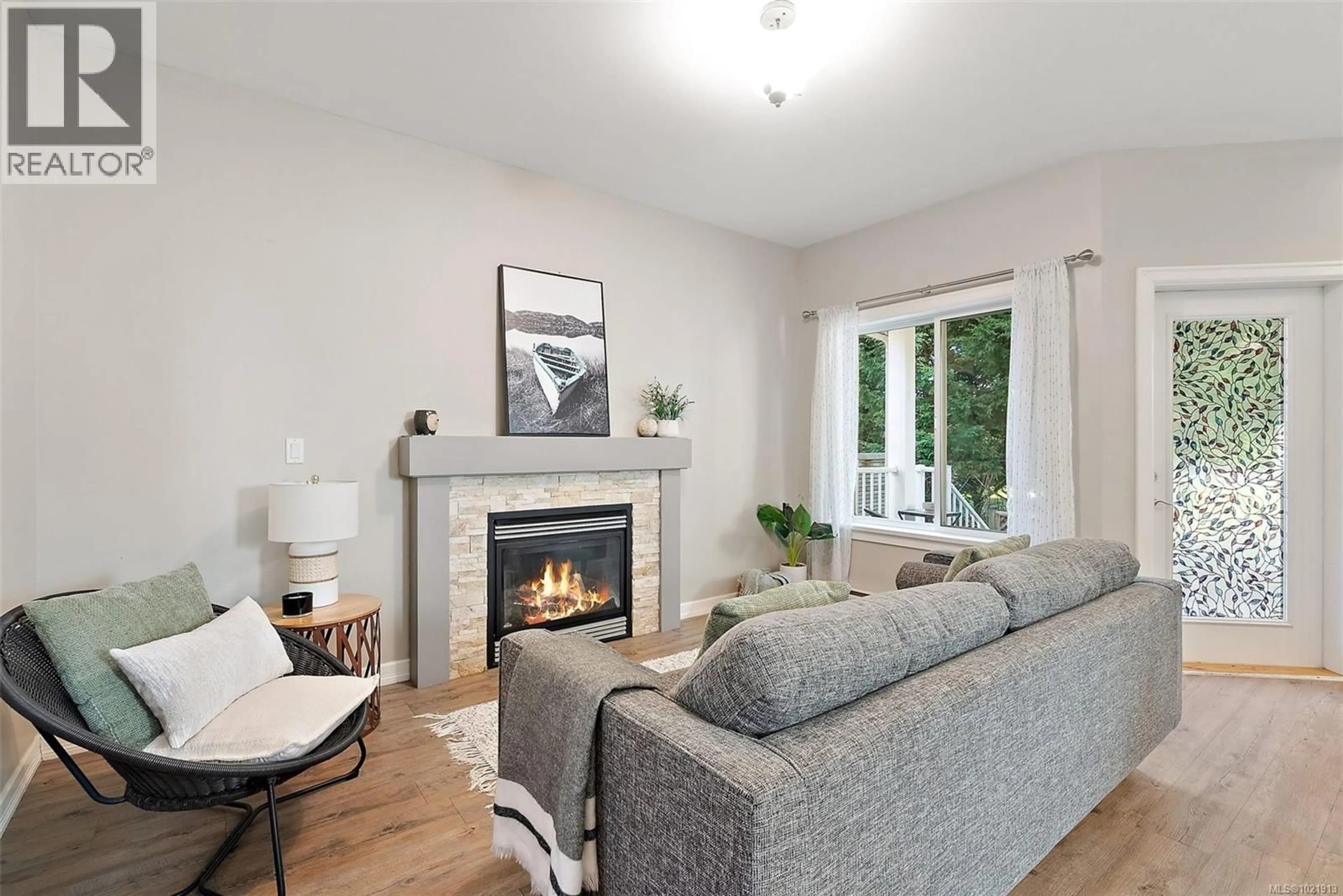 Living room with furniture, wood/laminate floor for 108 - 6800 GRANT ROAD WEST, Sooke British Columbia V9Z1K6