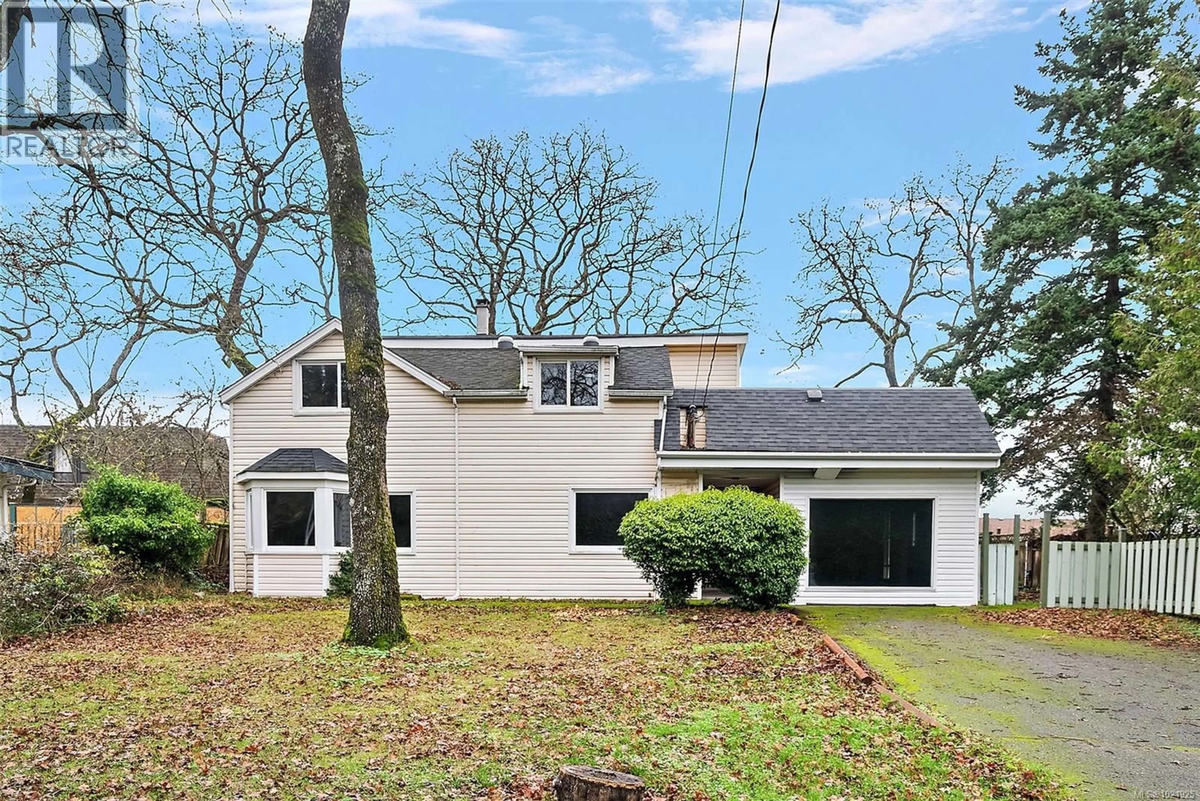 Home with vinyl exterior material, street for 1826 CEDAR HILL CROSS ROAD, Saanich British Columbia V8P2R4