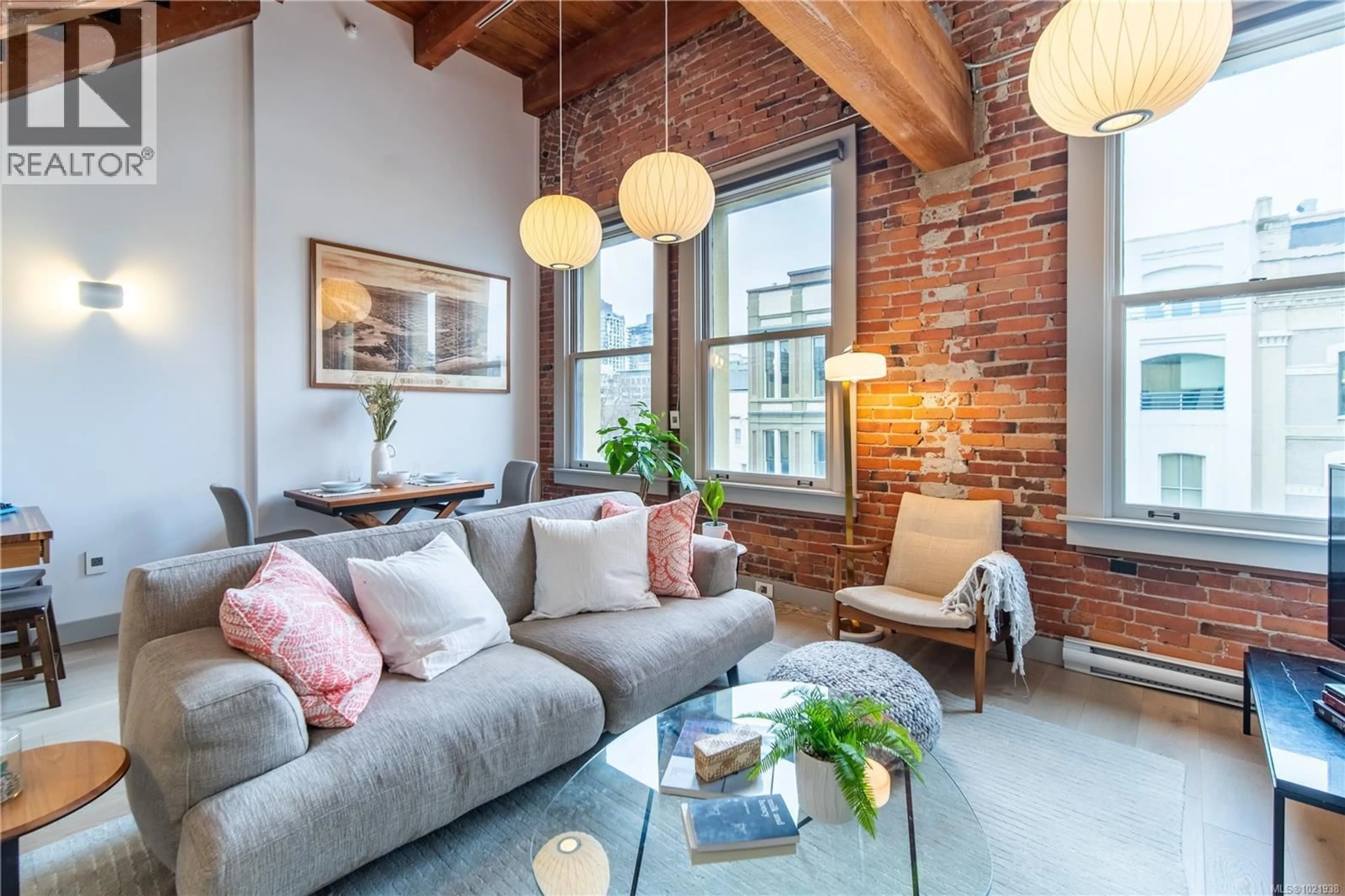 Living room with furniture, cement floor for 317 - 599 PANDORA AVENUE, Victoria British Columbia V8W1N5