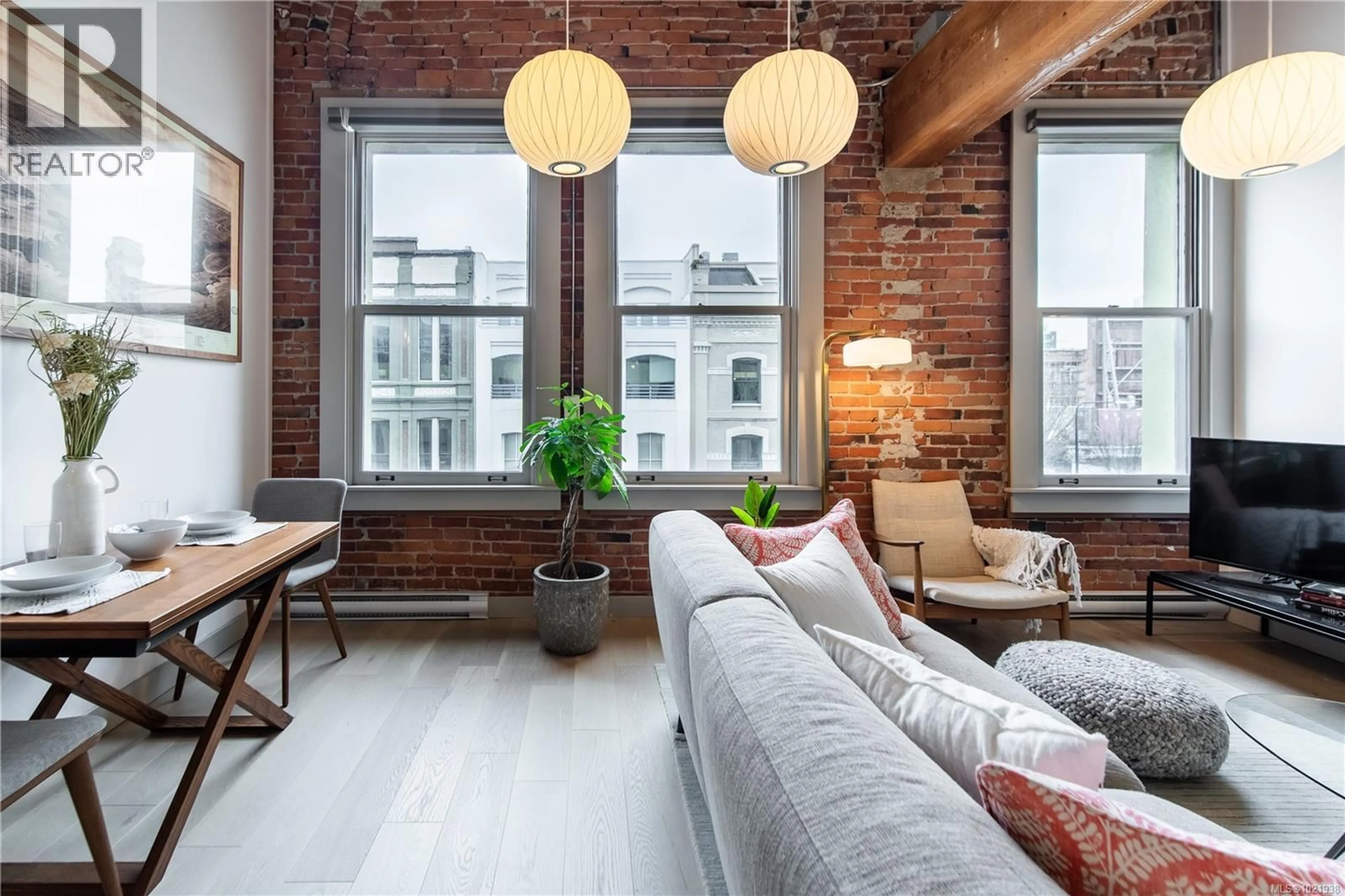 Living room with furniture, cement floor for 317 - 599 PANDORA AVENUE, Victoria British Columbia V8W1N5