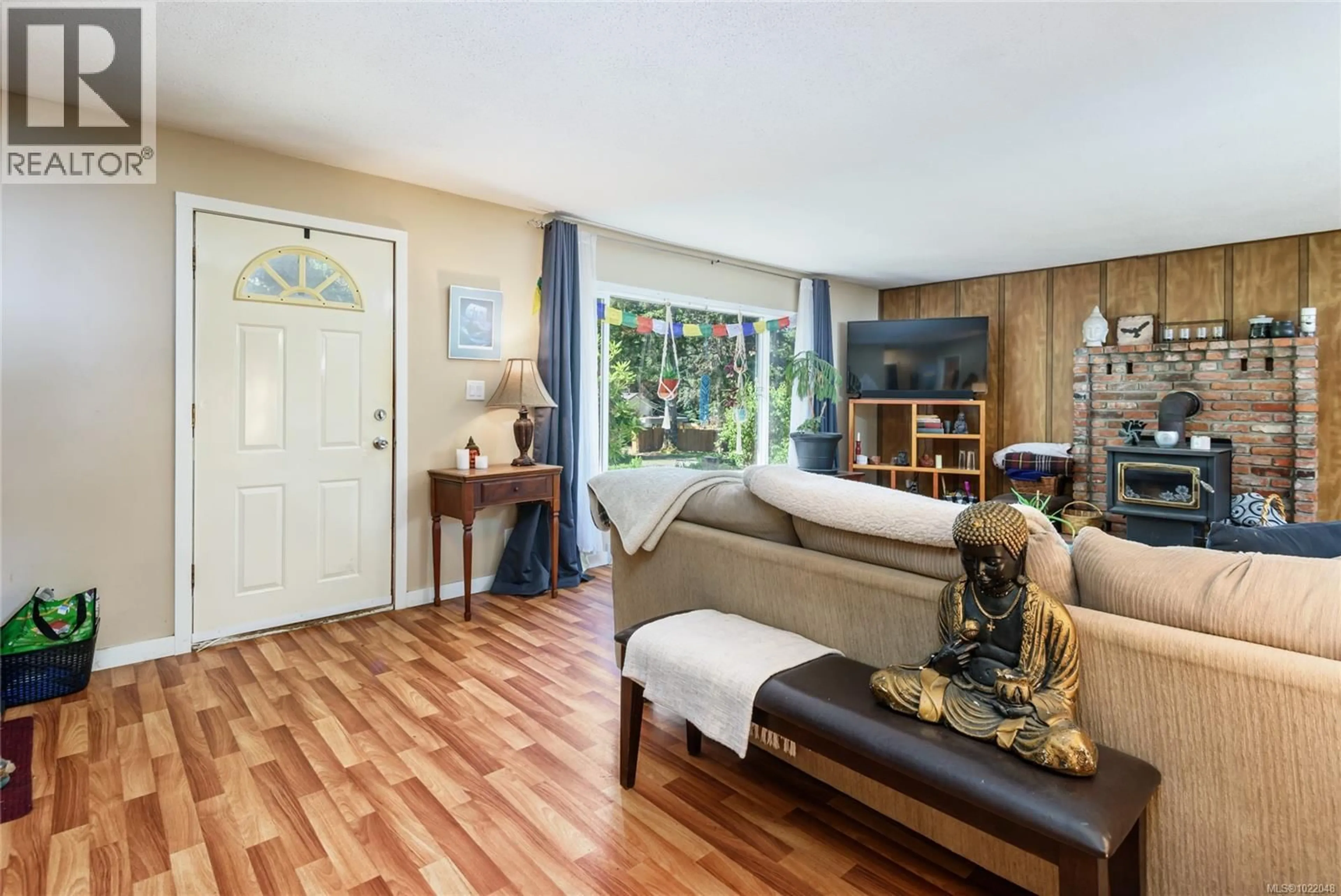 Living room with furniture, wood/laminate floor for 2030 BLACK CREEK ROAD, Black Creek British Columbia V9J1G5