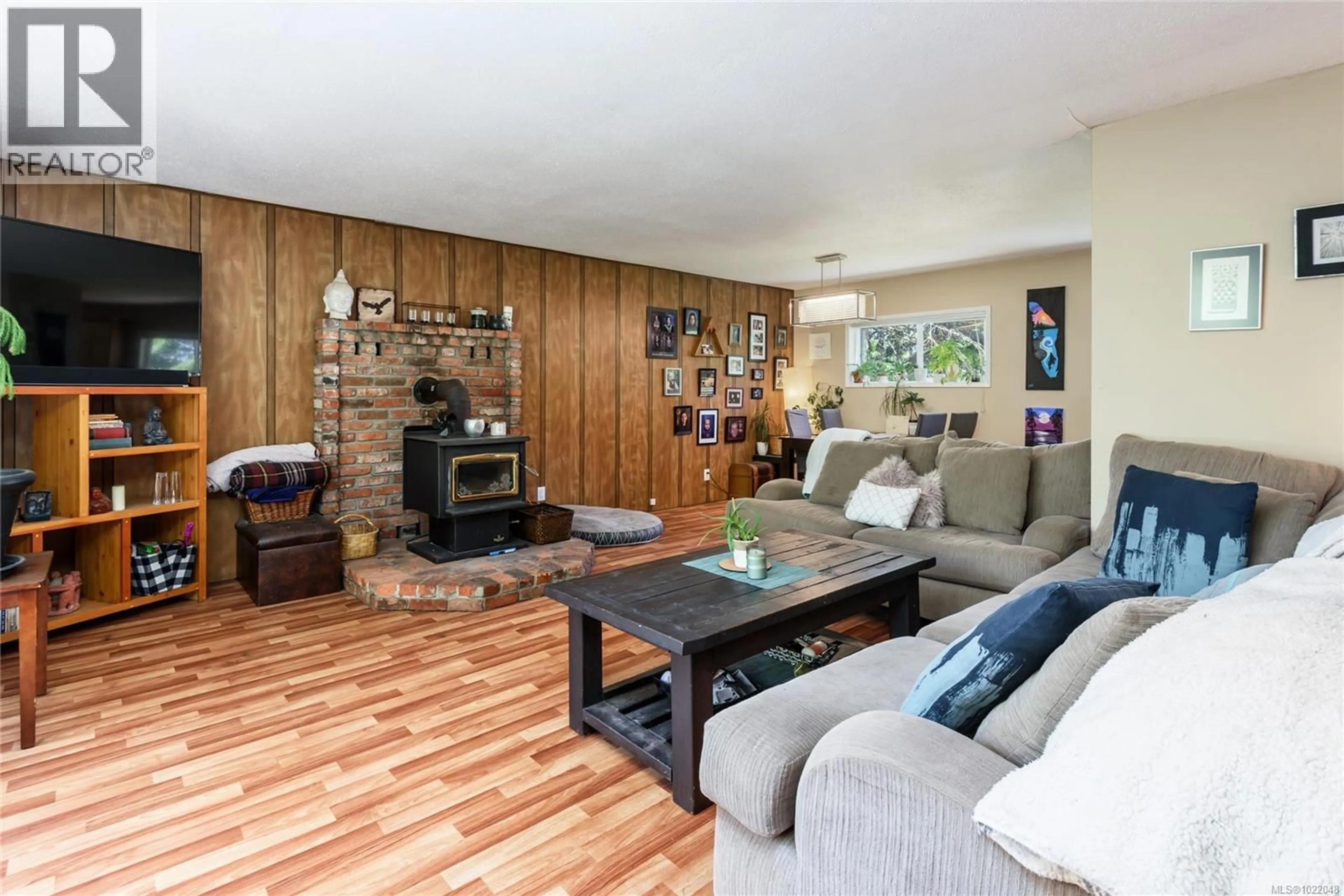 Living room with furniture, wood/laminate floor for 2030 BLACK CREEK ROAD, Black Creek British Columbia V9J1G5