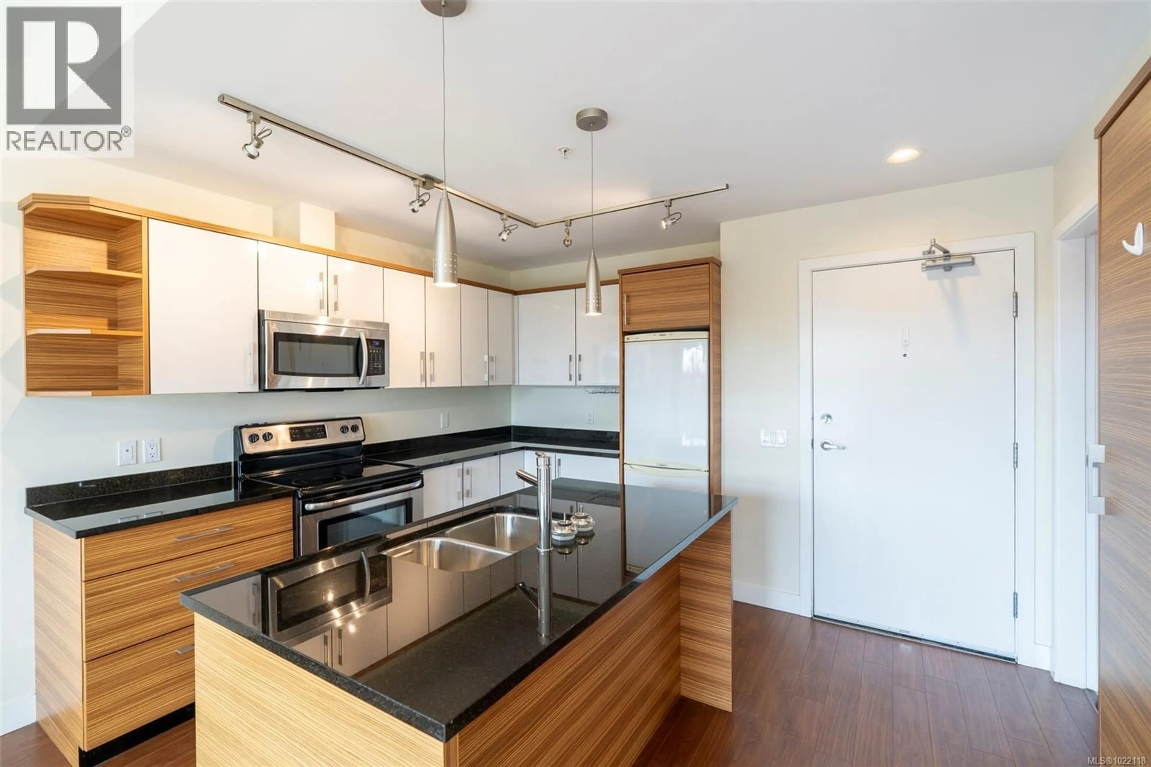 Open concept kitchen, wood/laminate floor for 402 - 4030 BORDEN STREET, Saanich British Columbia V8X2E9
