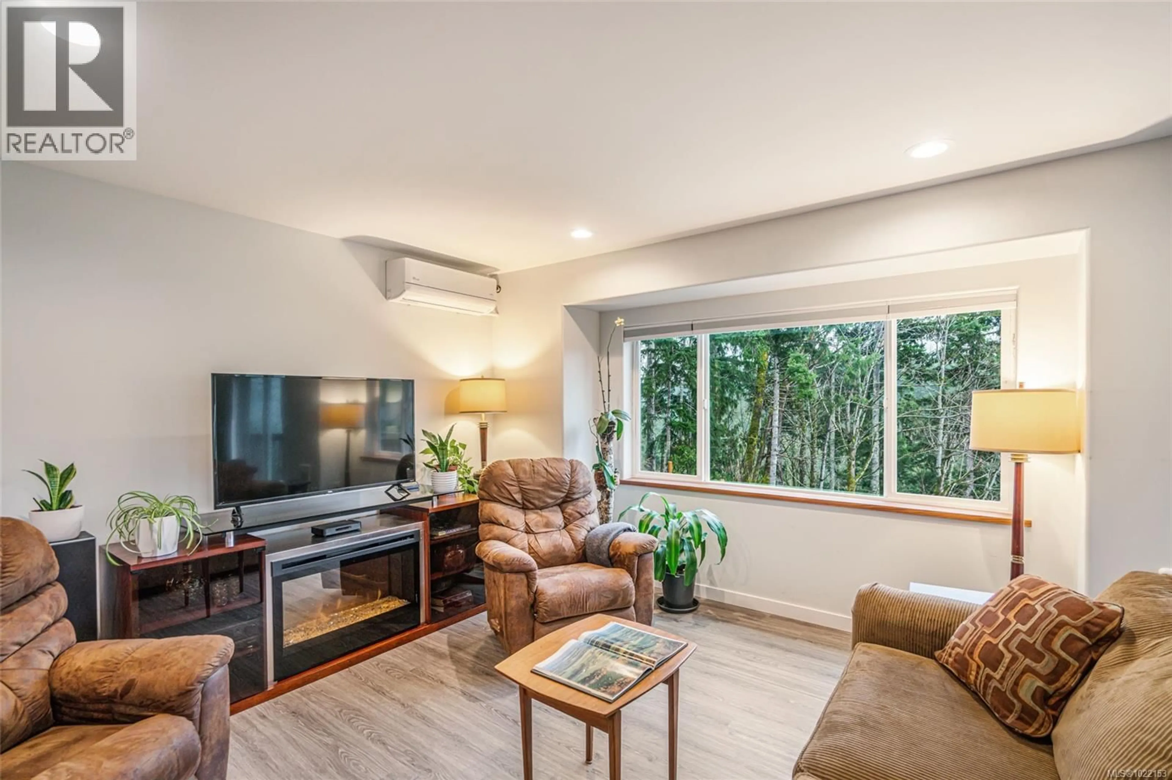 Living room with furniture, wood/laminate floor for 1778 CANUCK CRESCENT, Qualicum Beach British Columbia V9K2S3