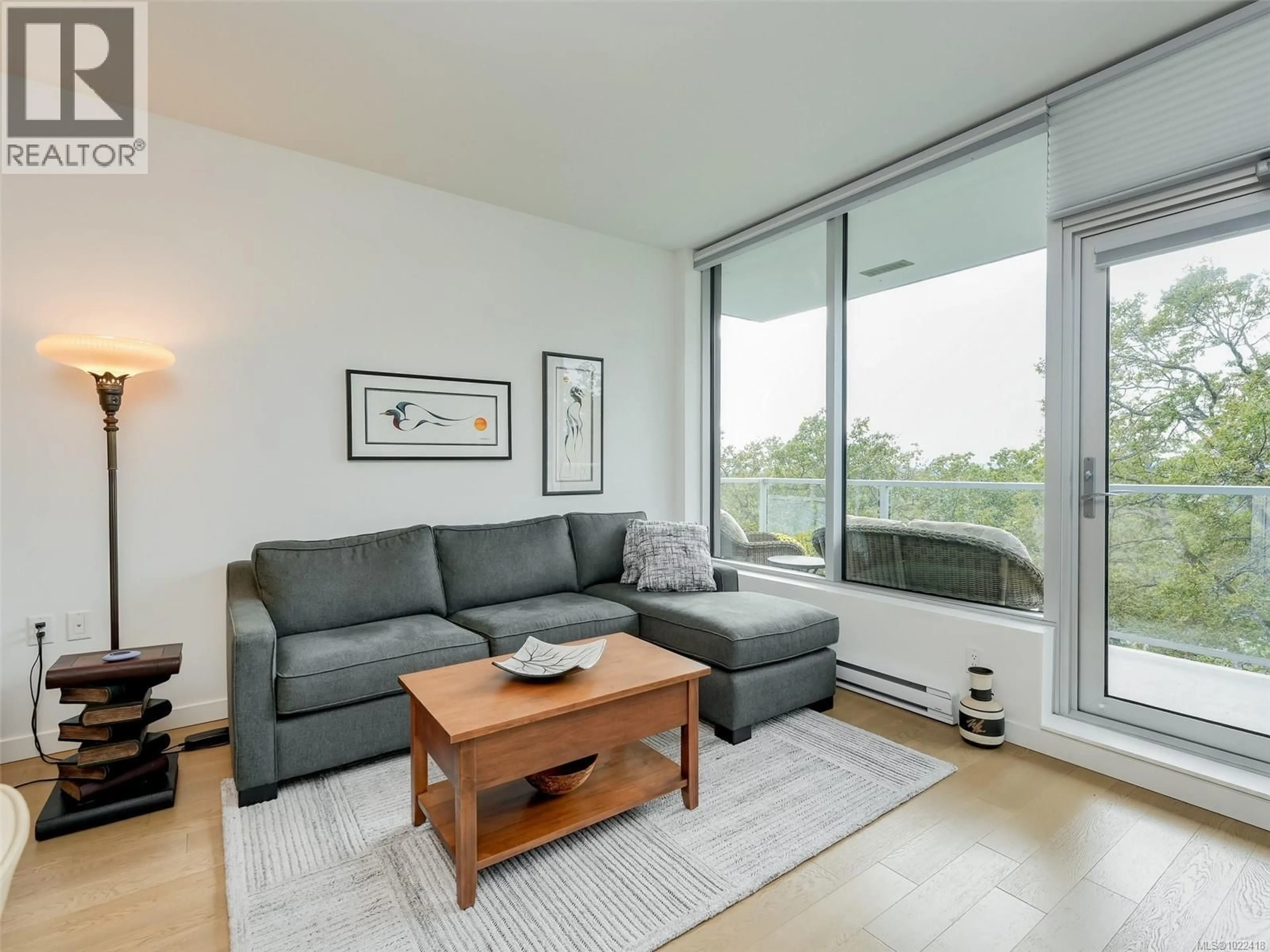 Living room with furniture, wood/laminate floor for 603 - 4009 RAINBOW HILL LANE, Saanich British Columbia V8X0B3