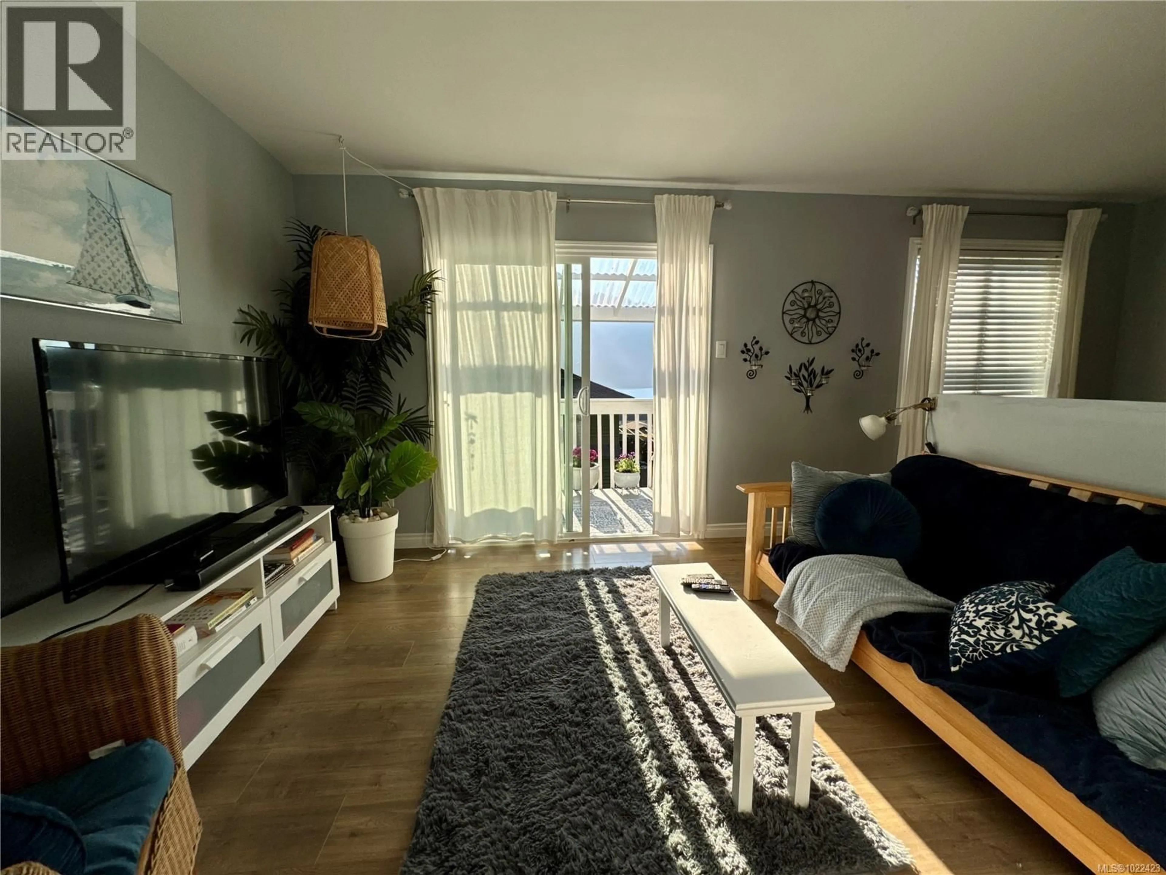 Living room with furniture, wood/laminate floor for 38 CLARK DRIVE, Port Alice British Columbia V0N2N0
