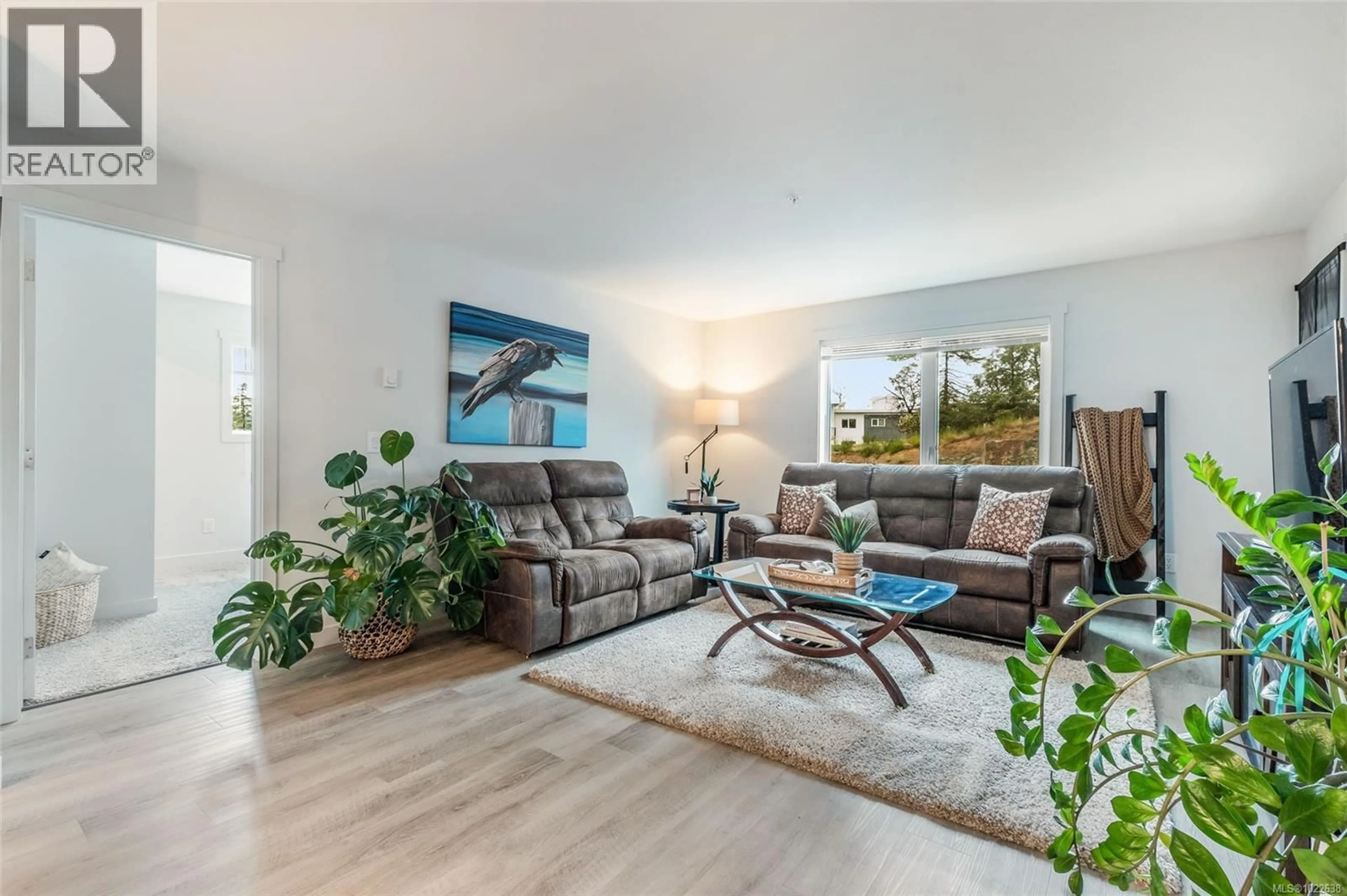 Living room with furniture, wood/laminate floor for 202 - 4820 CEDAR RIDGE PLACE, Nanaimo British Columbia V9T0M7