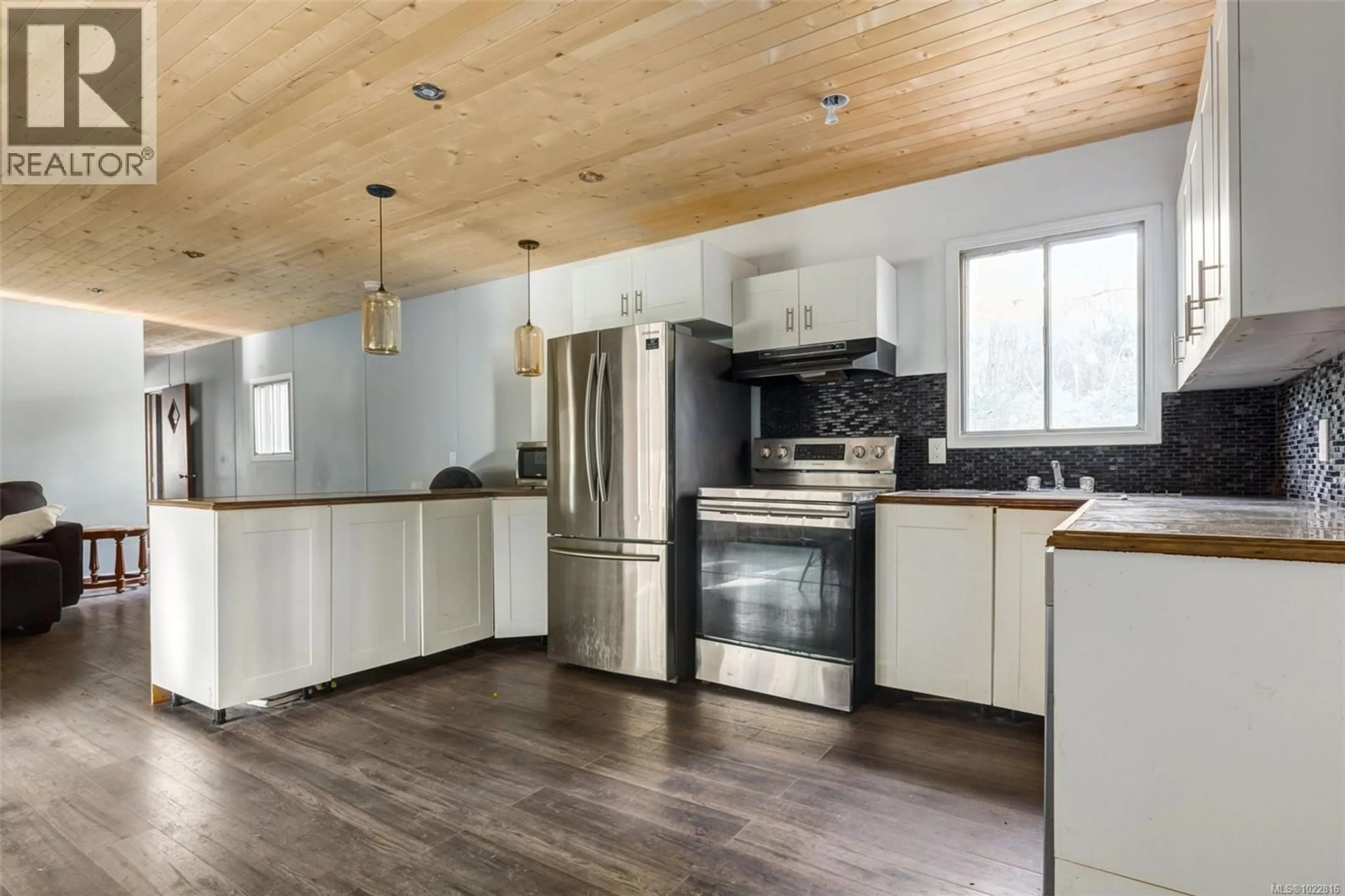 Open concept kitchen, wood/laminate floor for 1900 MARTIN ROAD, Gabriola Island British Columbia V0R1X7