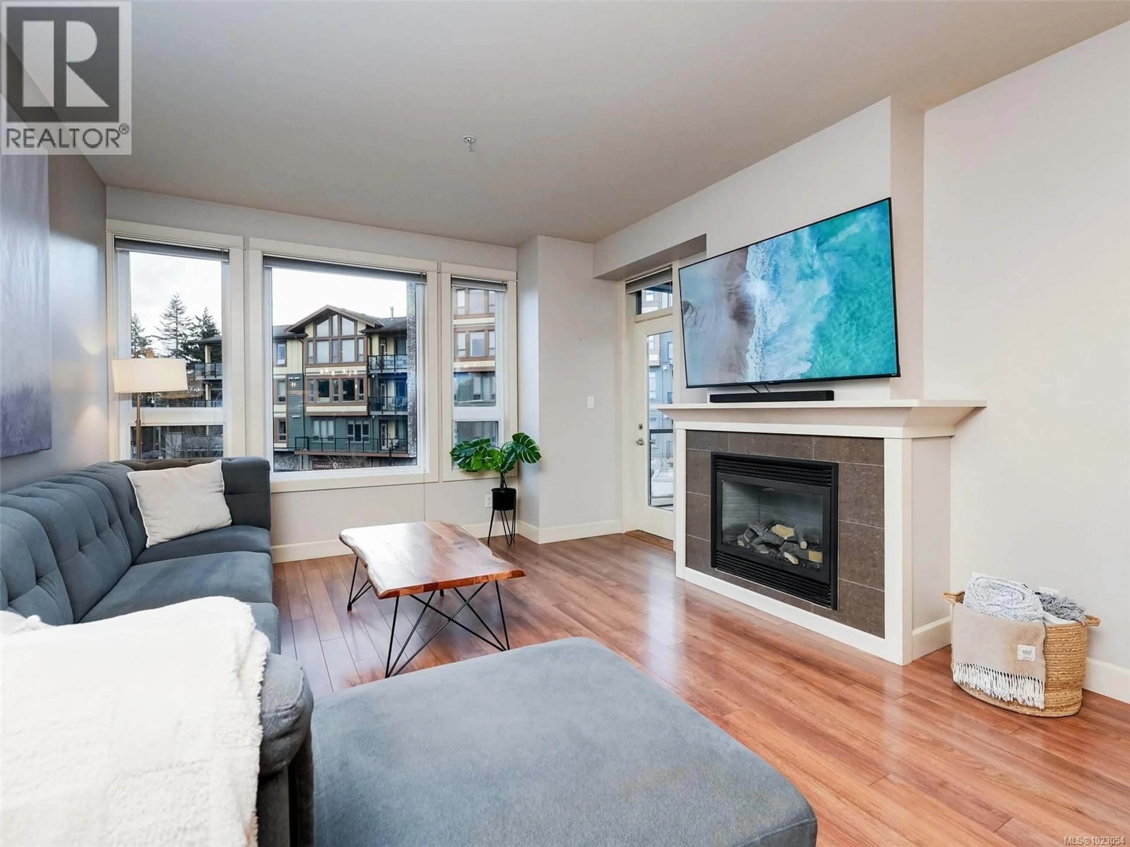 Living room with furniture, wood/laminate floor for 204 - 3220 JACKLIN ROAD, Langford British Columbia V9B0J5