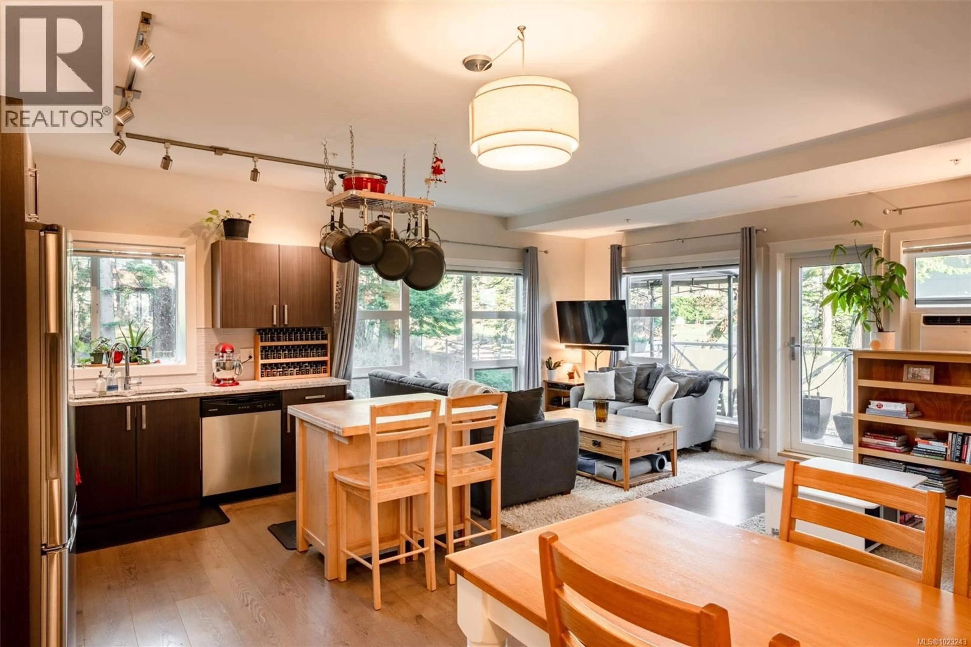 Open concept kitchen, wood/laminate floor for 208 - 1900 WATKISS WAY, View Royal British Columbia V9B0B6