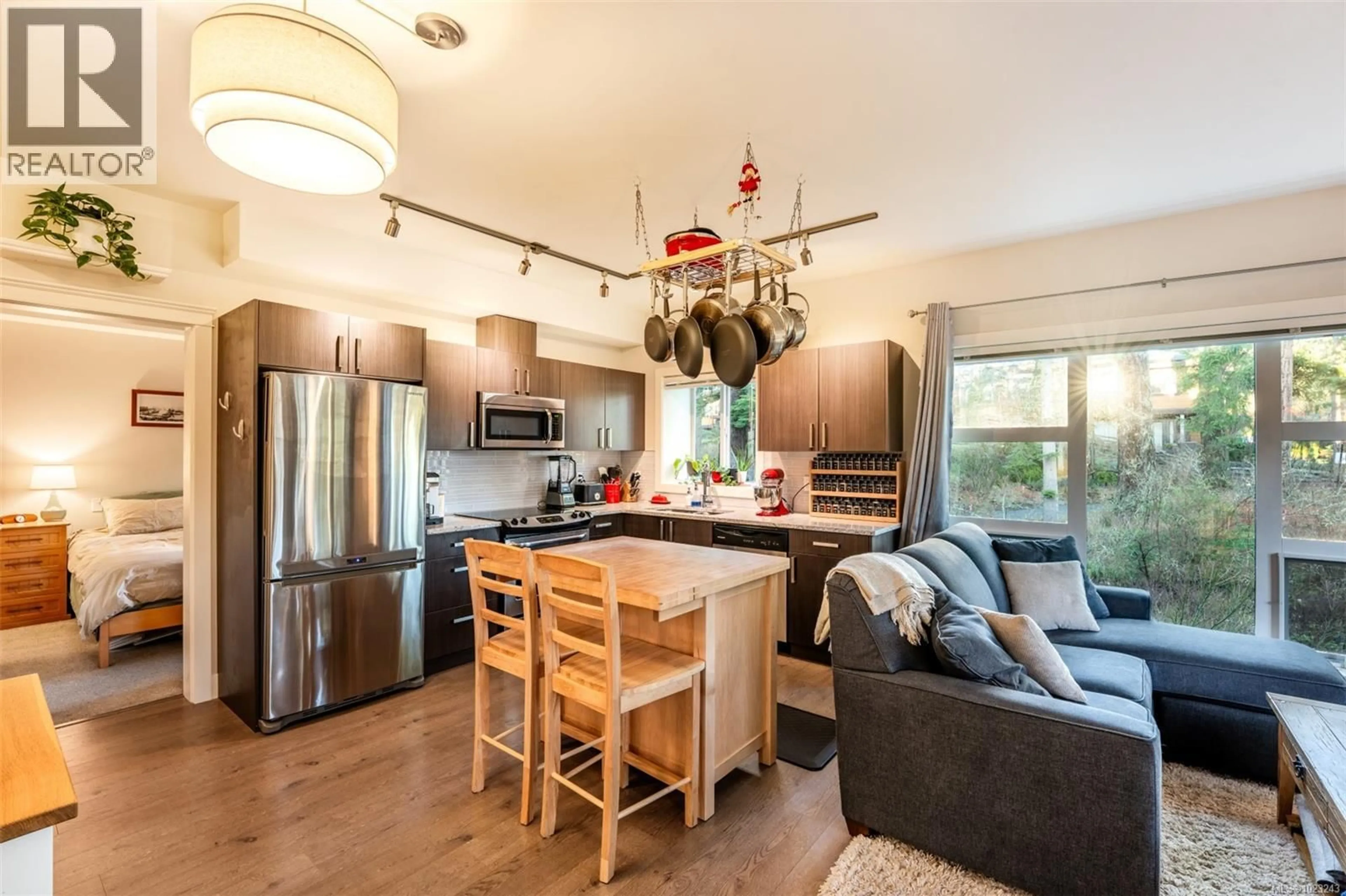 Open concept kitchen, wood/laminate floor for 208 - 1900 WATKISS WAY, View Royal British Columbia V9B0B6