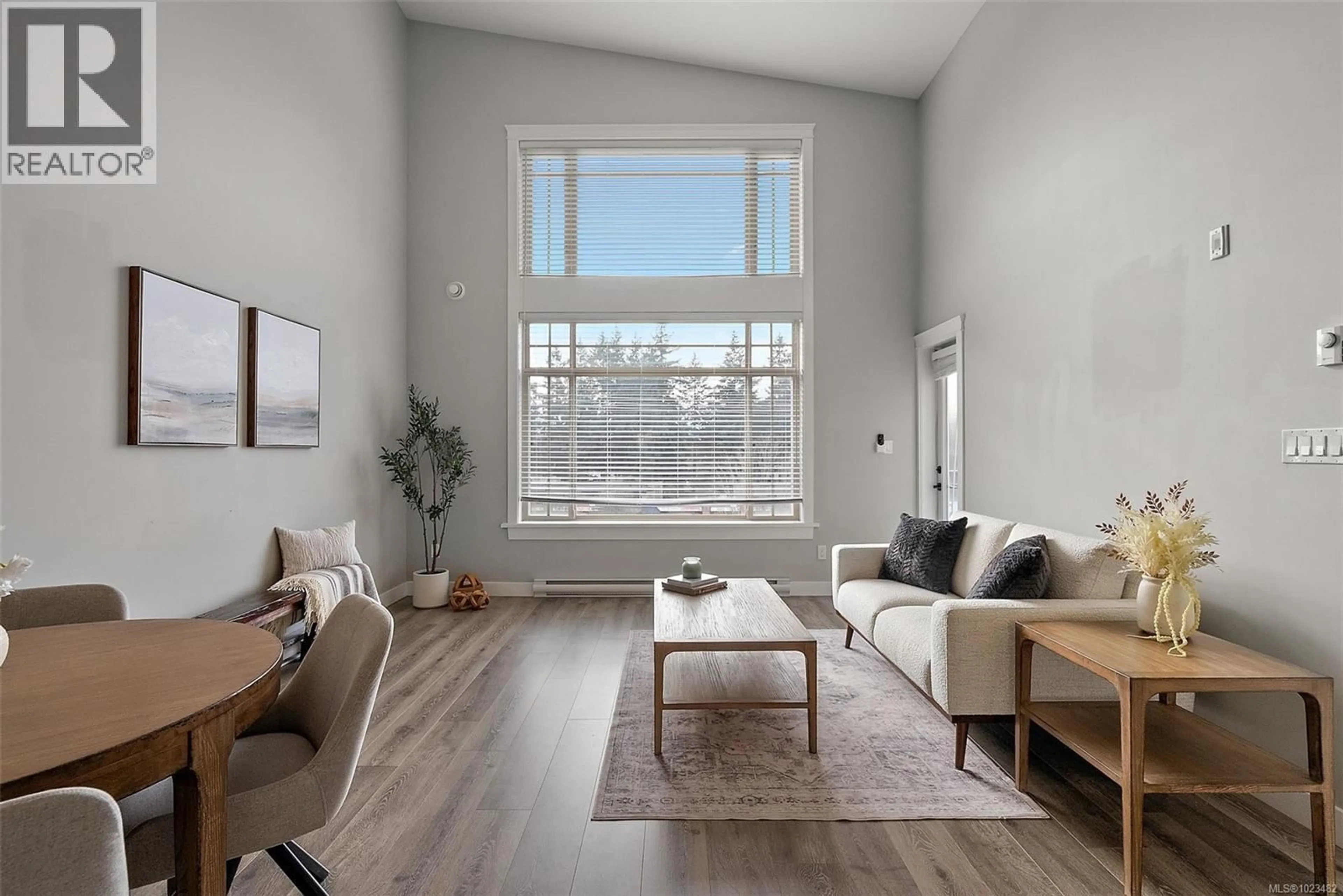 Living room with furniture, wood/laminate floor for 403 - 844 GOLDSTREAM AVENUE, Langford British Columbia V9B2X7