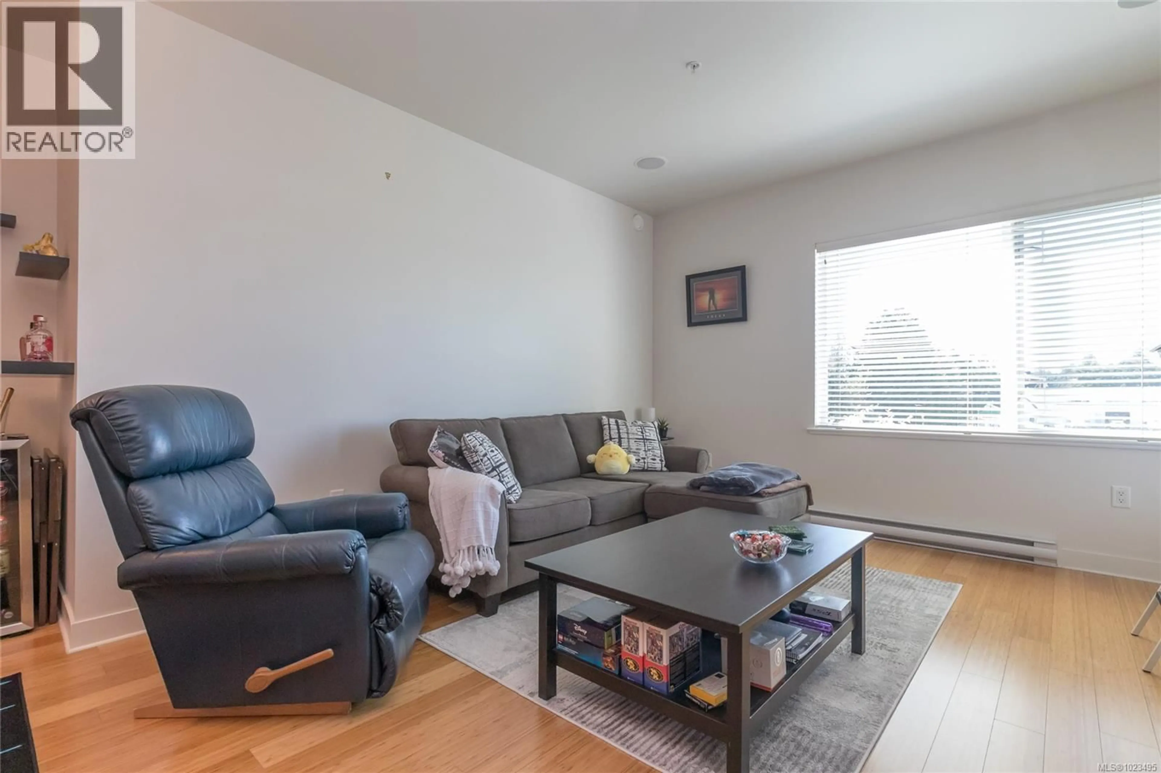 Living room with furniture, wood/laminate floor for 205 - 4394 WEST SAANICH ROAD, Saanich British Columbia V8Z0B5