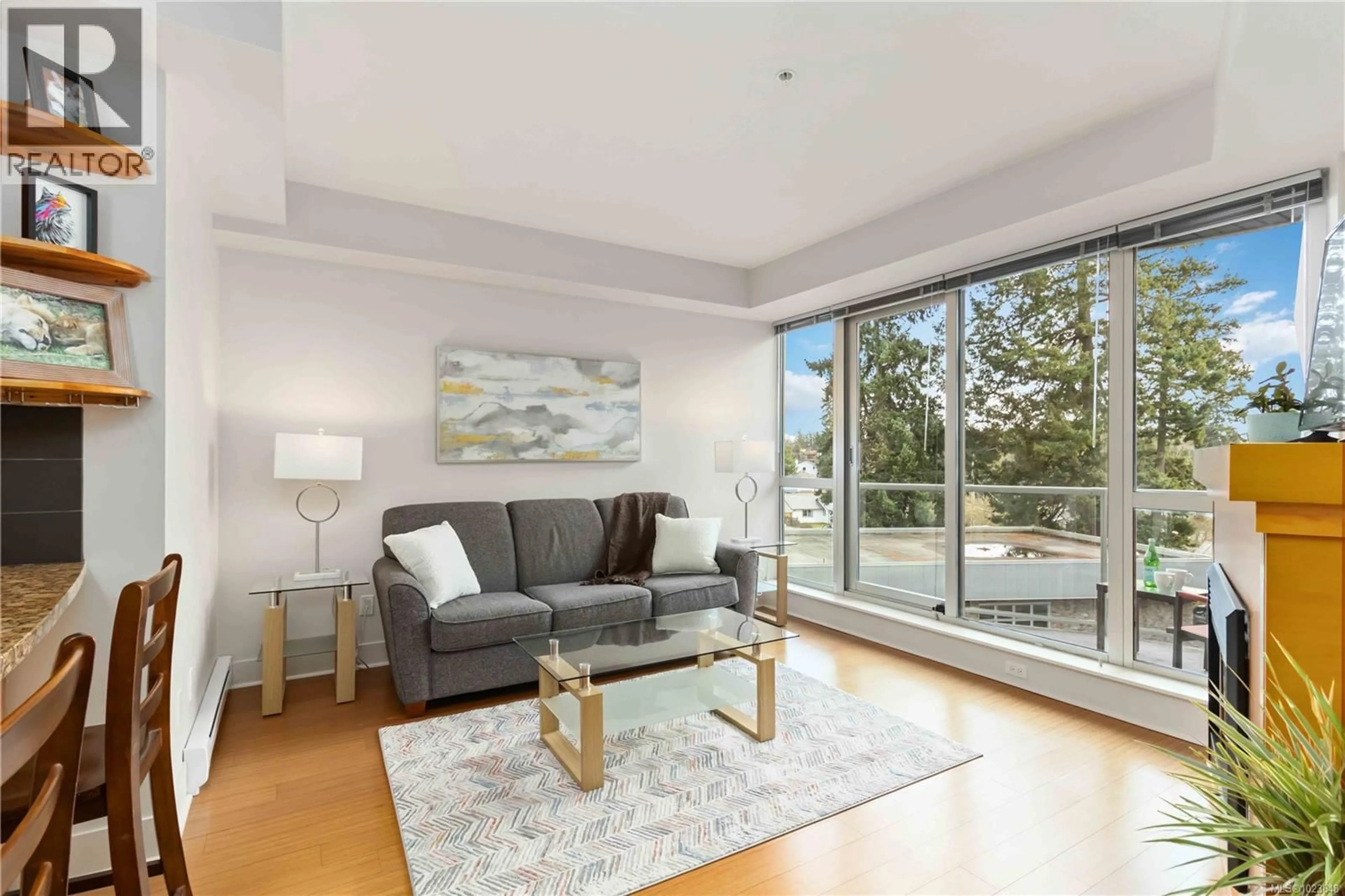 Living room with furniture, wood/laminate floor for 407 - 2745 VETERANS MEMORIAL PARKWAY, Langford British Columbia V9B0H4