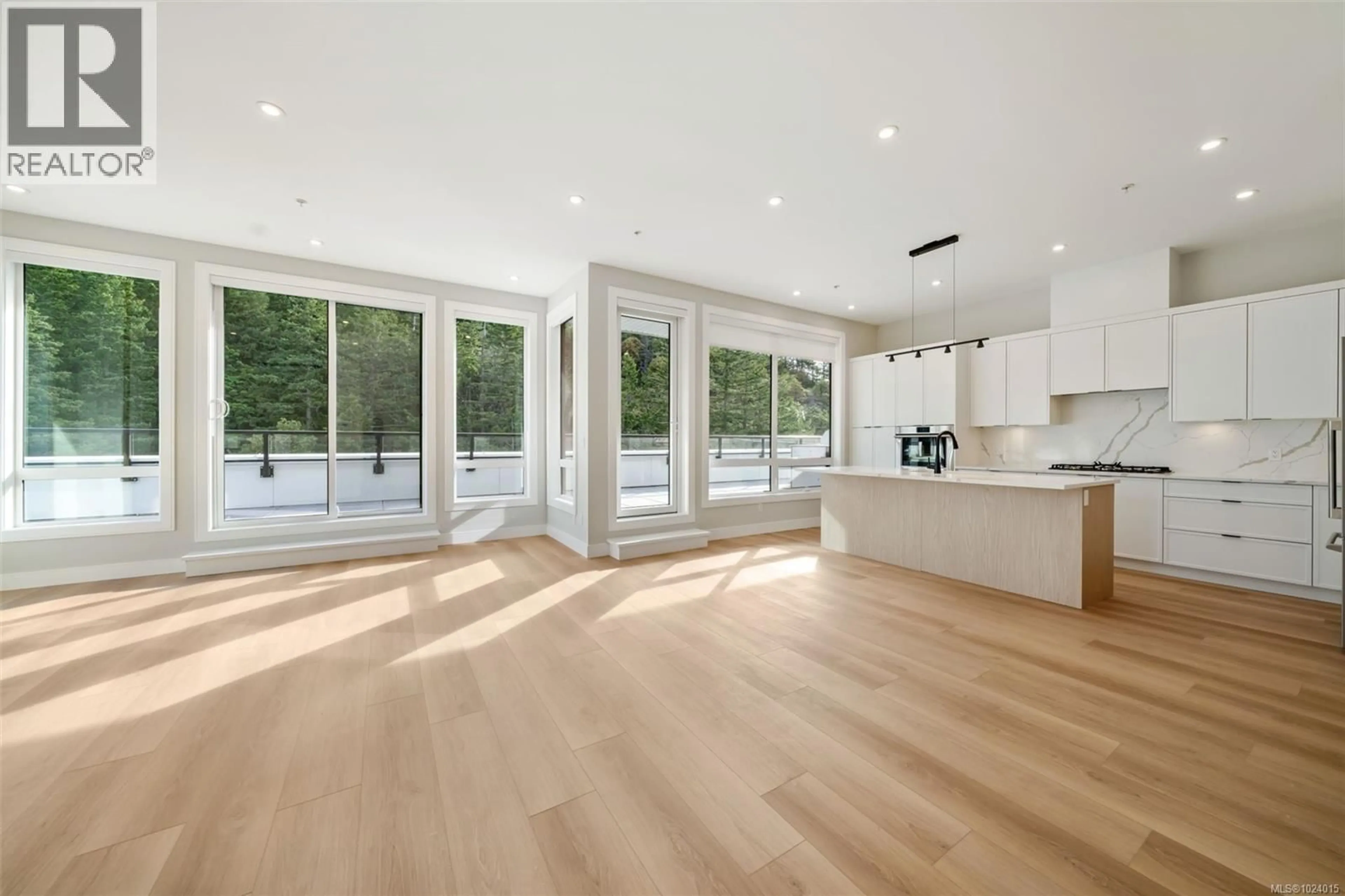 Open concept kitchen, wood/laminate floor for 601 - 1810 SELENITE PLACE, Langford British Columbia V9B7E2