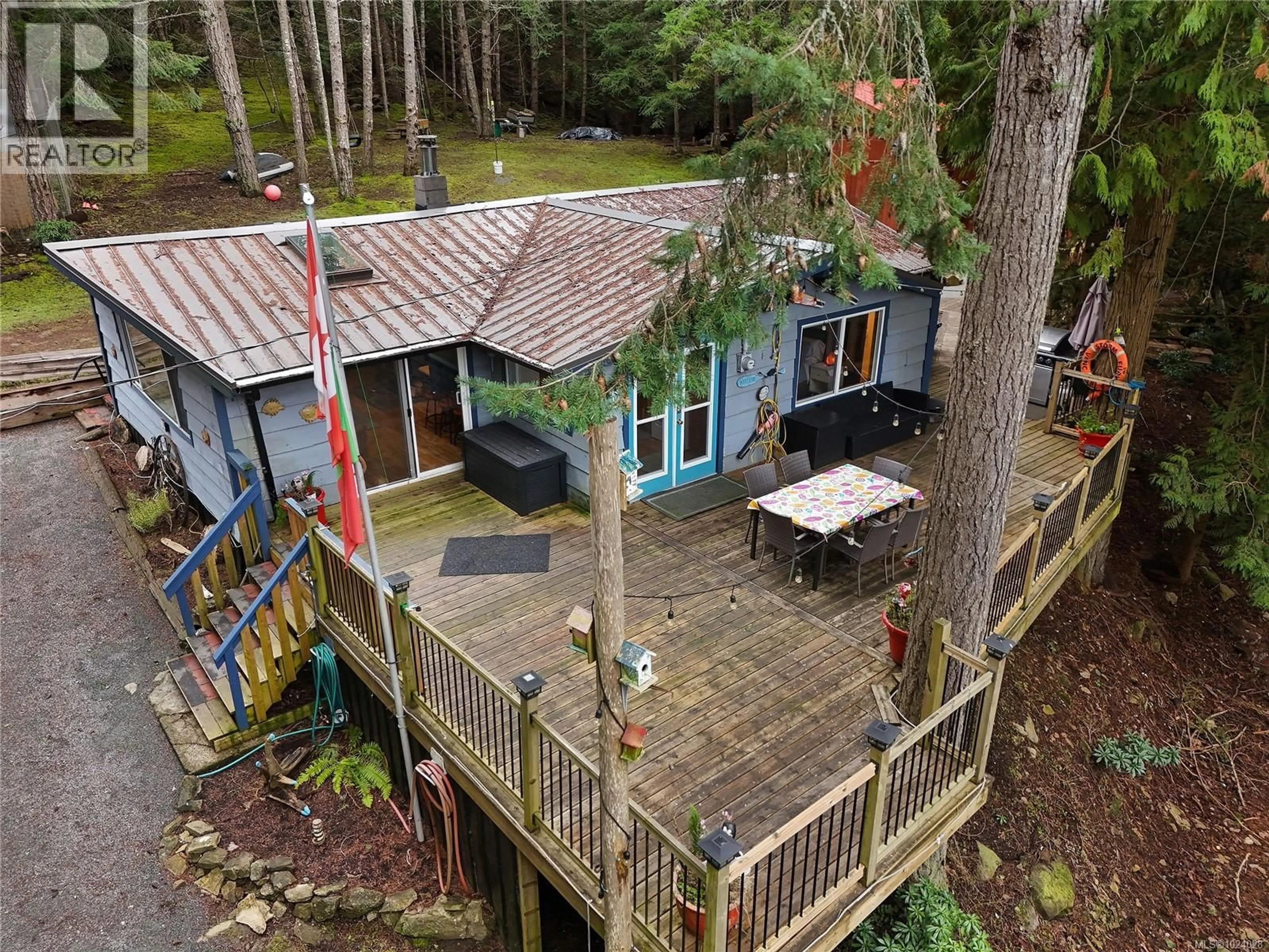 A pic from outside/outdoor area/front of a property/back of a property/a pic from drone, forest/trees view for 493 ABBOTT ROAD, Mayne Island British Columbia V0N2J1
