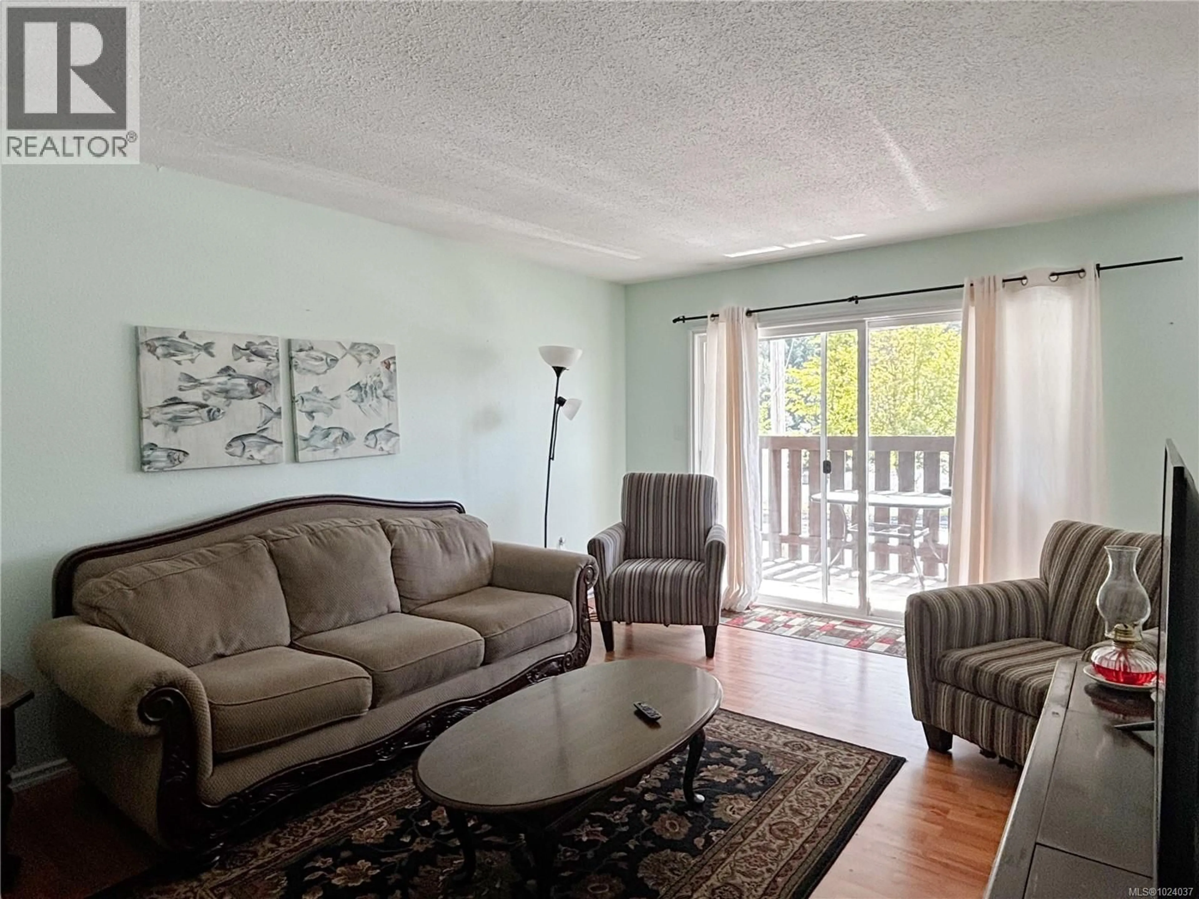 Living room with furniture, wood/laminate floor for 324 ALPINE VIEW ROAD, Tahsis British Columbia V0P1X0