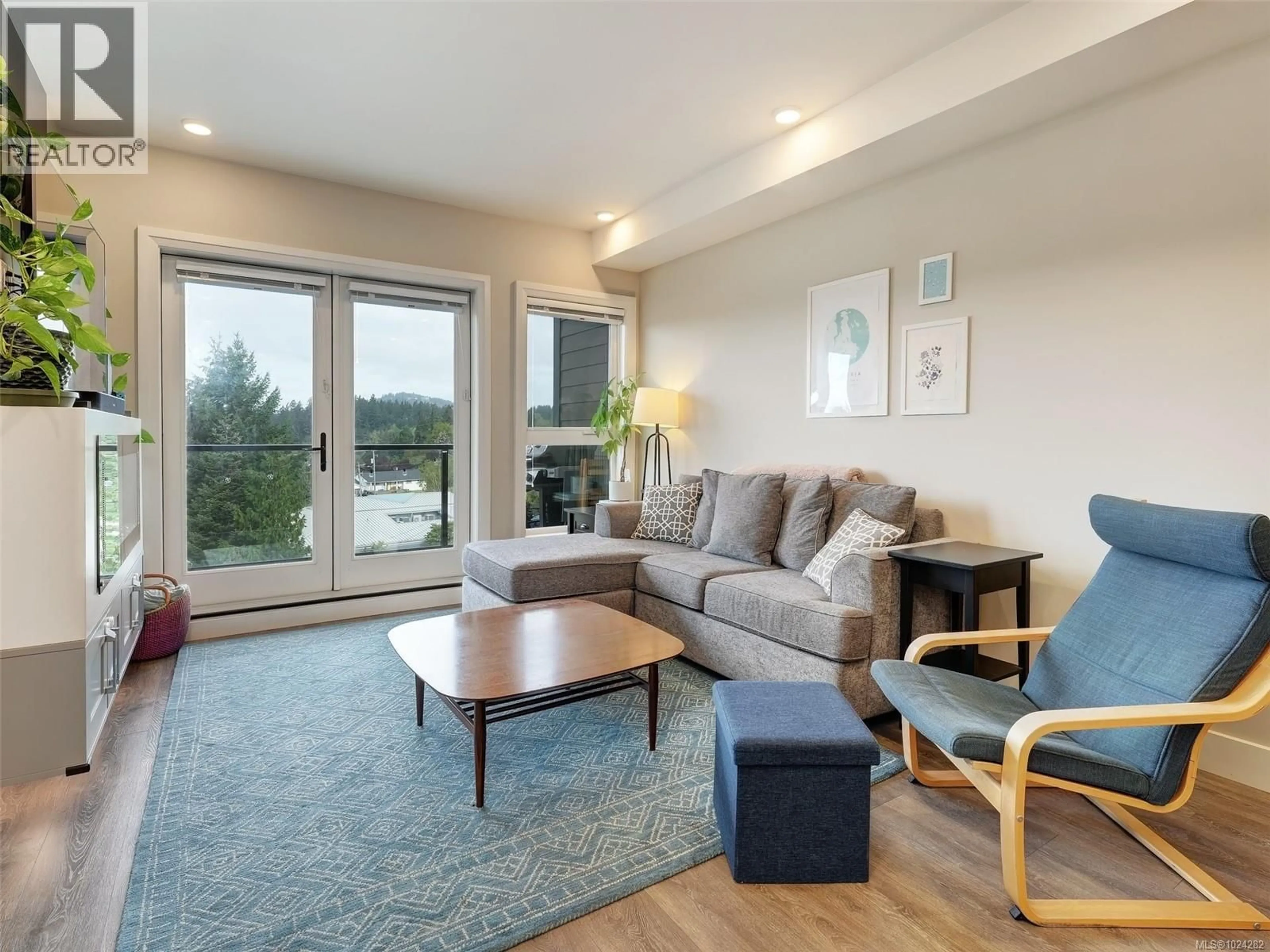 Living room with furniture, wood/laminate floor for 503 - 741 TRAVINO LANE, Saanich British Columbia V8Z0E5
