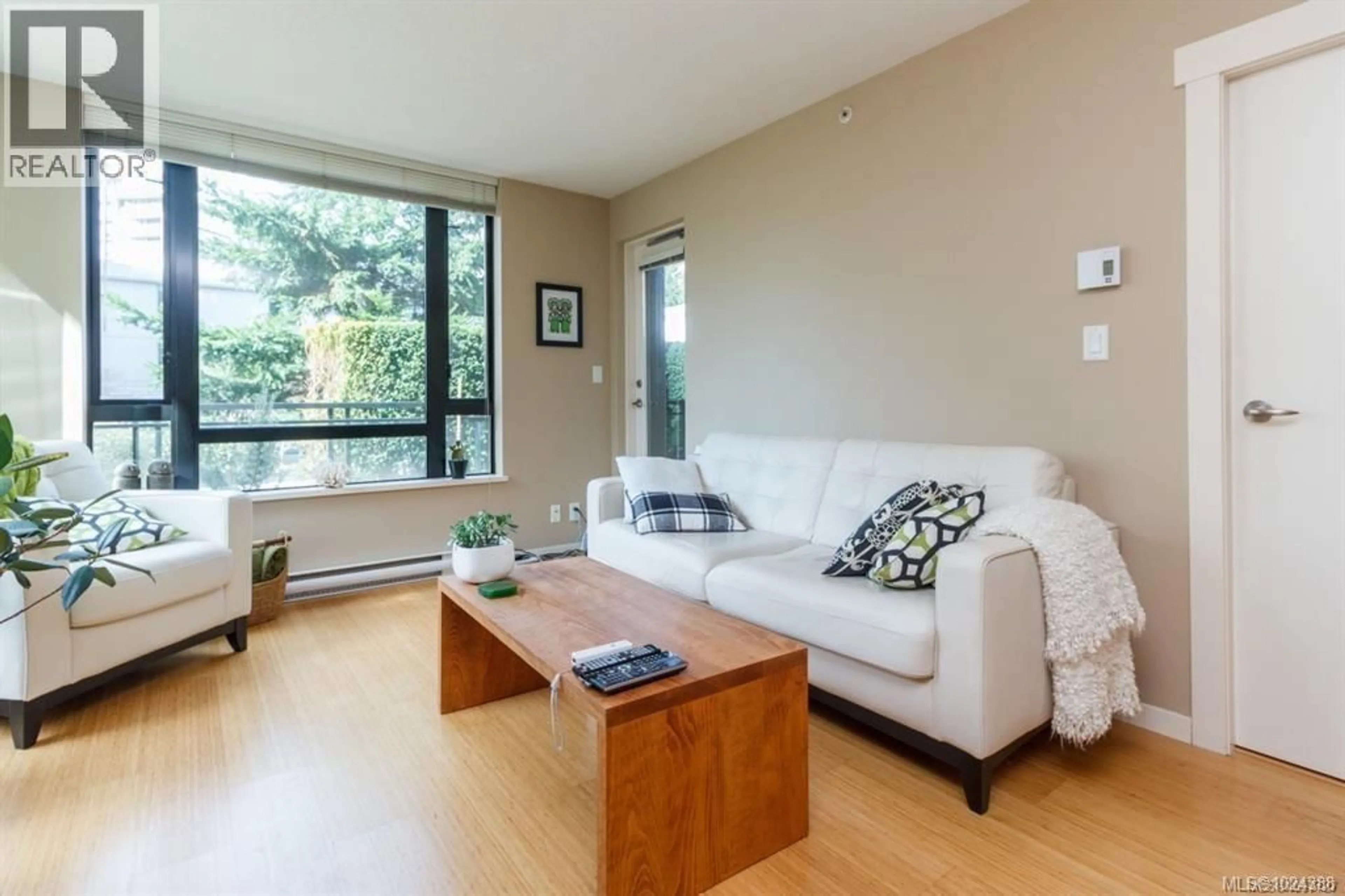 Living room with furniture, wood/laminate floor for 110 - 751 FAIRFIELD ROAD, Victoria British Columbia V8W3Z5