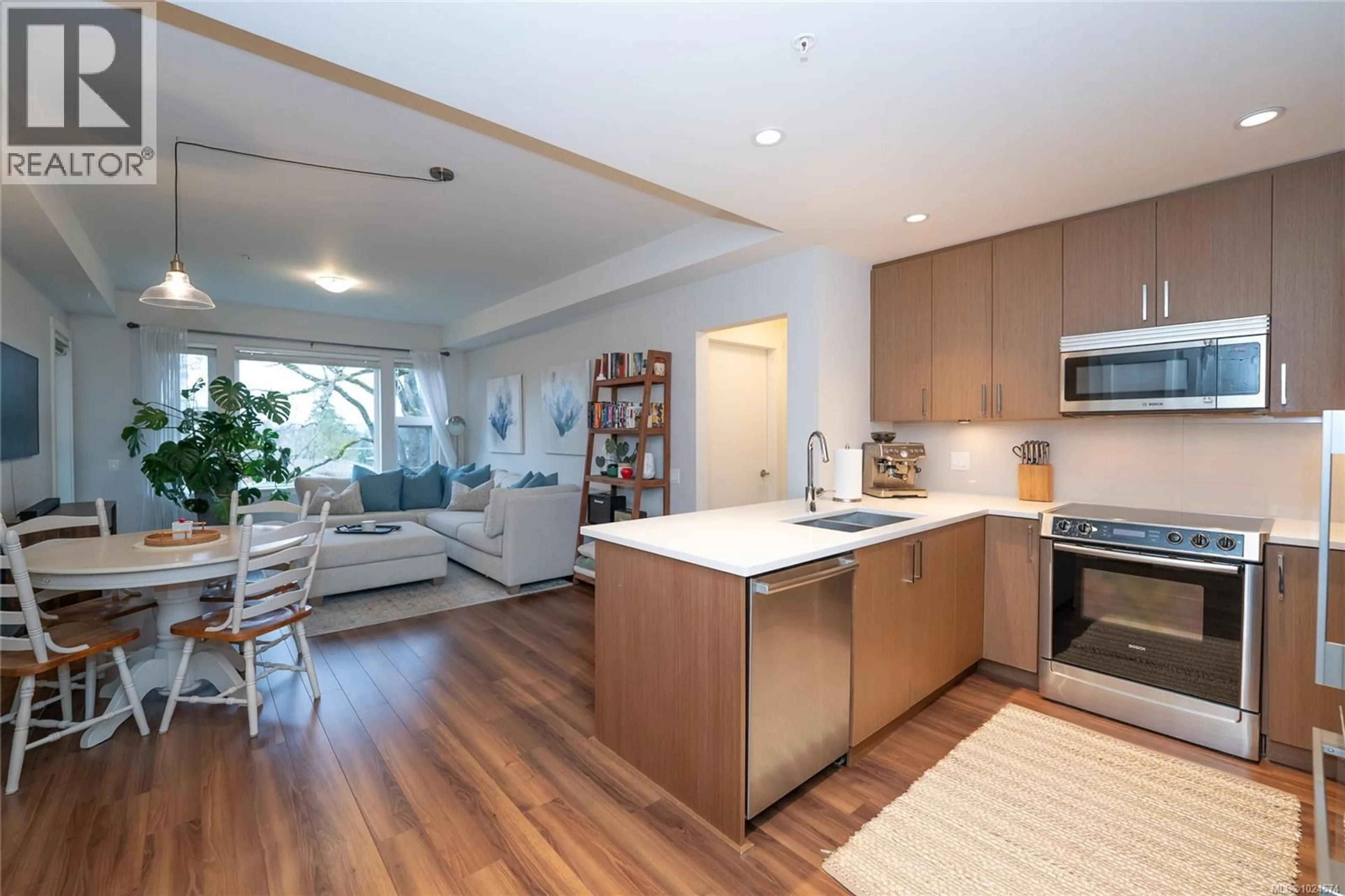 Open concept kitchen, wood/laminate floor for 302 - 3912 CAREY ROAD, Saanich British Columbia V8Z4E2