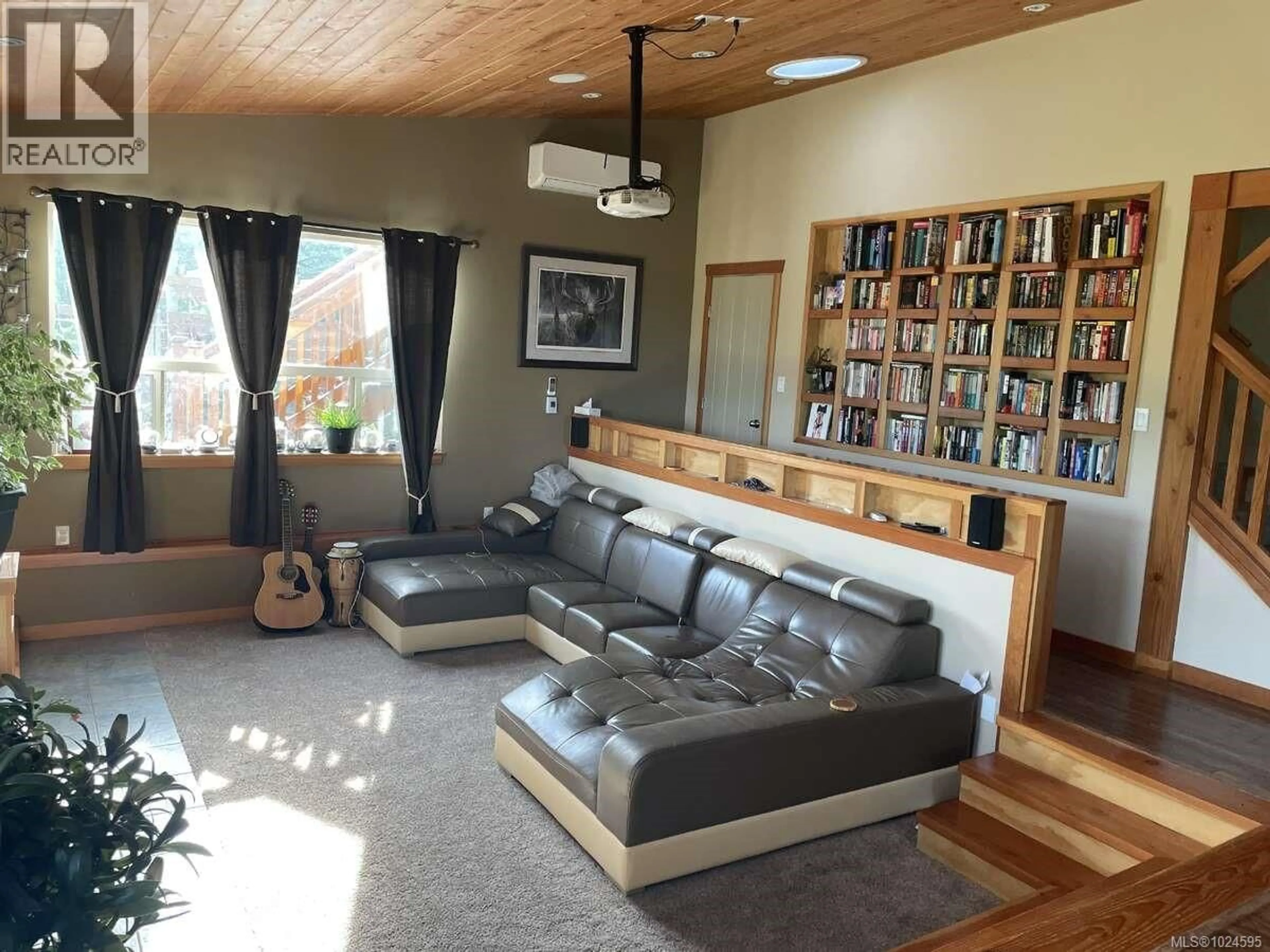 Living room with furniture, wood/laminate floor for 1680 PELIGREN PLACE, Qualicum Beach British Columbia V9K2S3