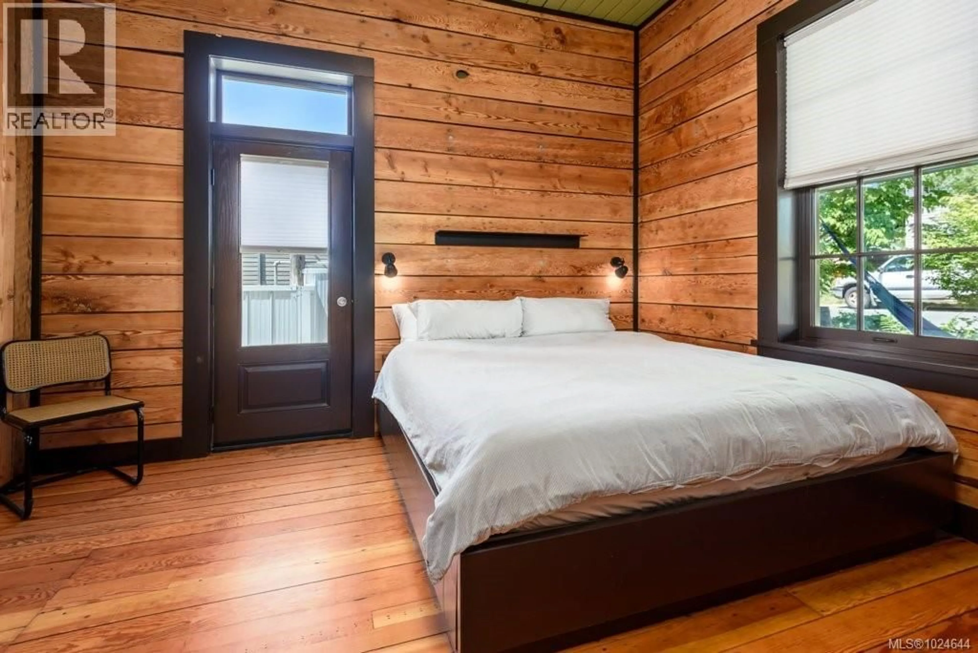 Bedroom with bed, wood/laminate floor for 2613 DUNSMUIR AVENUE, Cumberland British Columbia V0R1S0