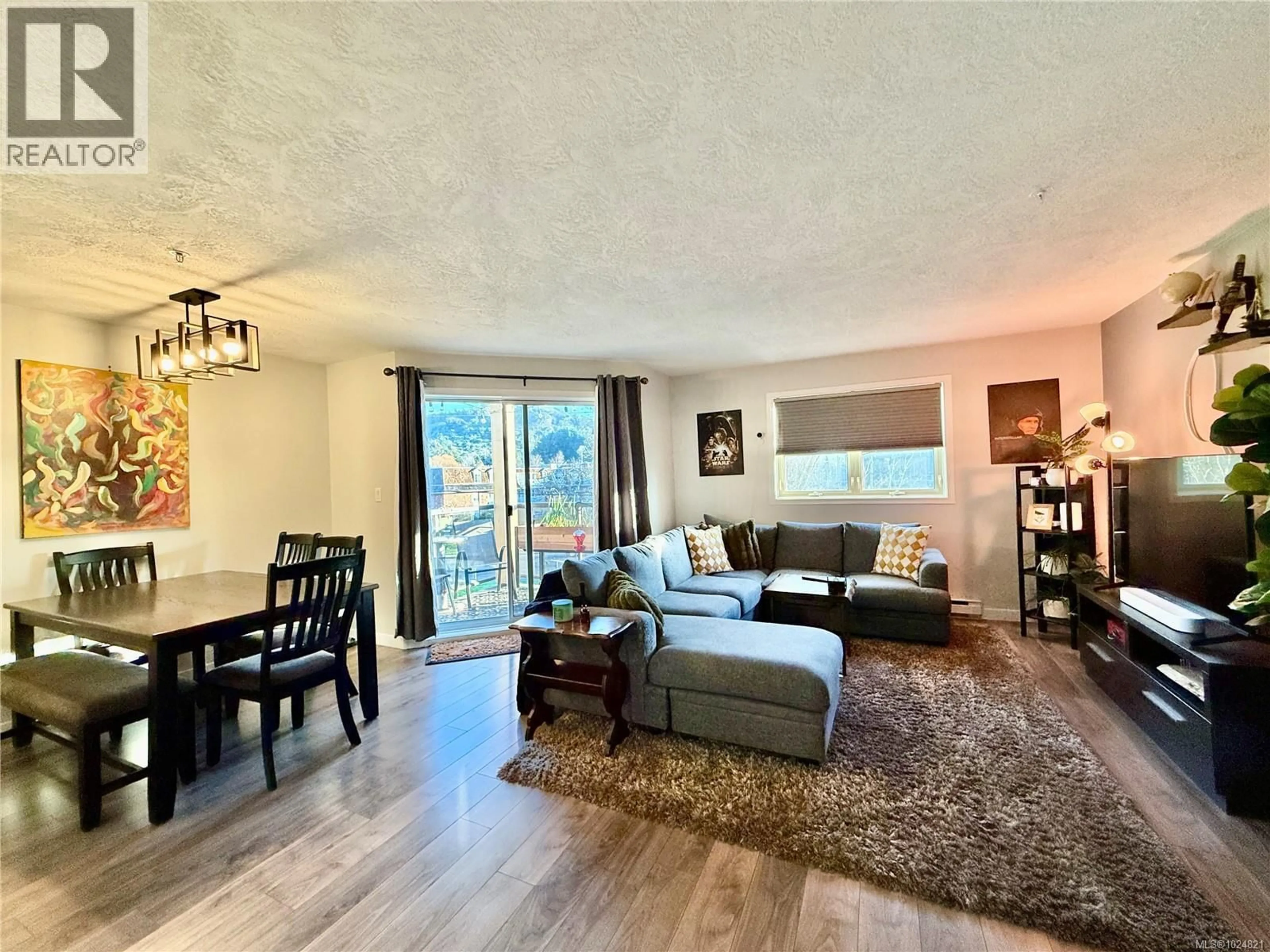 Living room with furniture, wood/laminate floor for 302 - 1694 CEDAR HILL CROSS ROAD, Saanich British Columbia V8P2P7