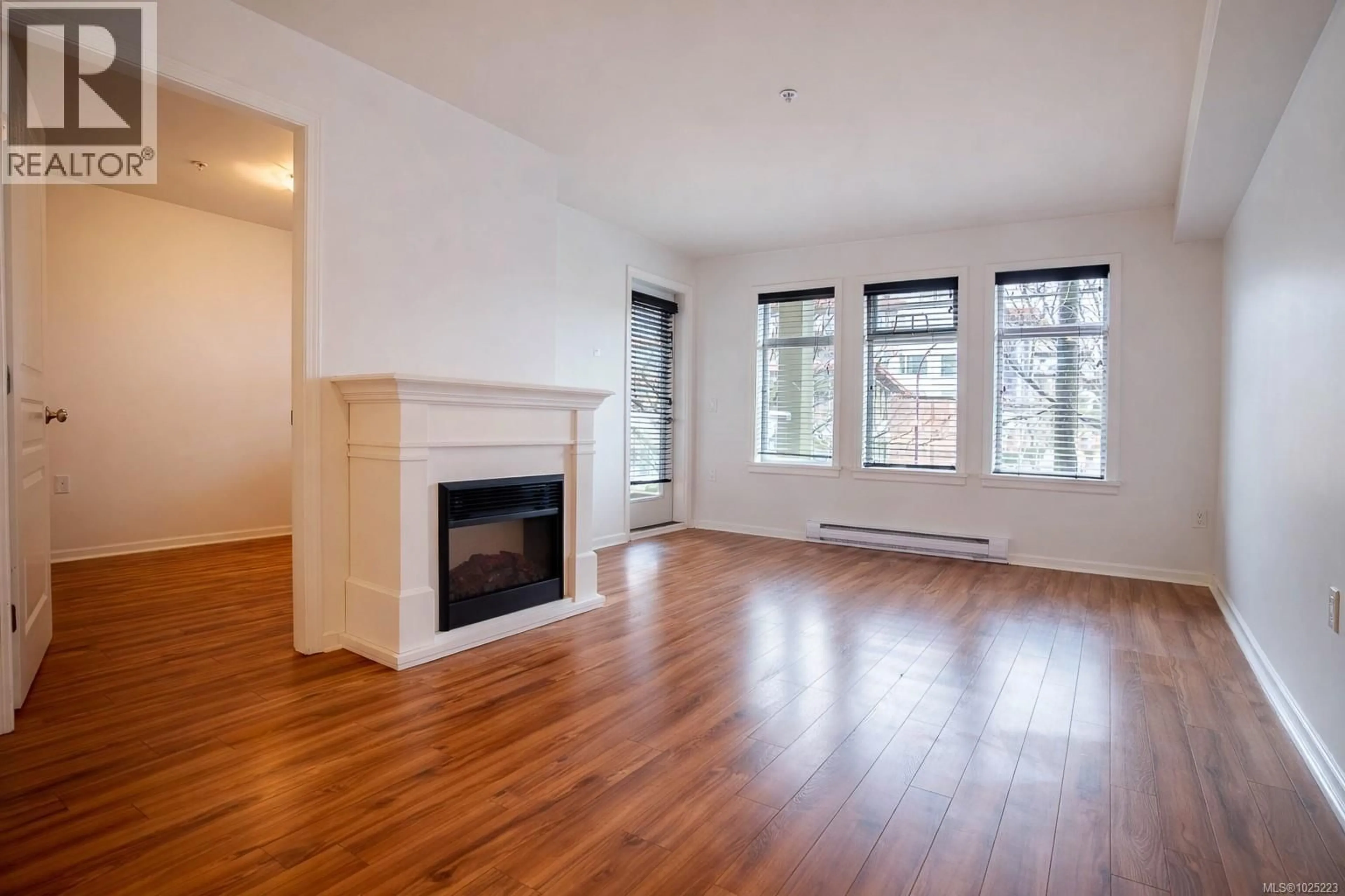 Living room with furniture, wood/laminate floor for 210 - 655 GOLDSTREAM AVENUE, Langford British Columbia V9B0G2