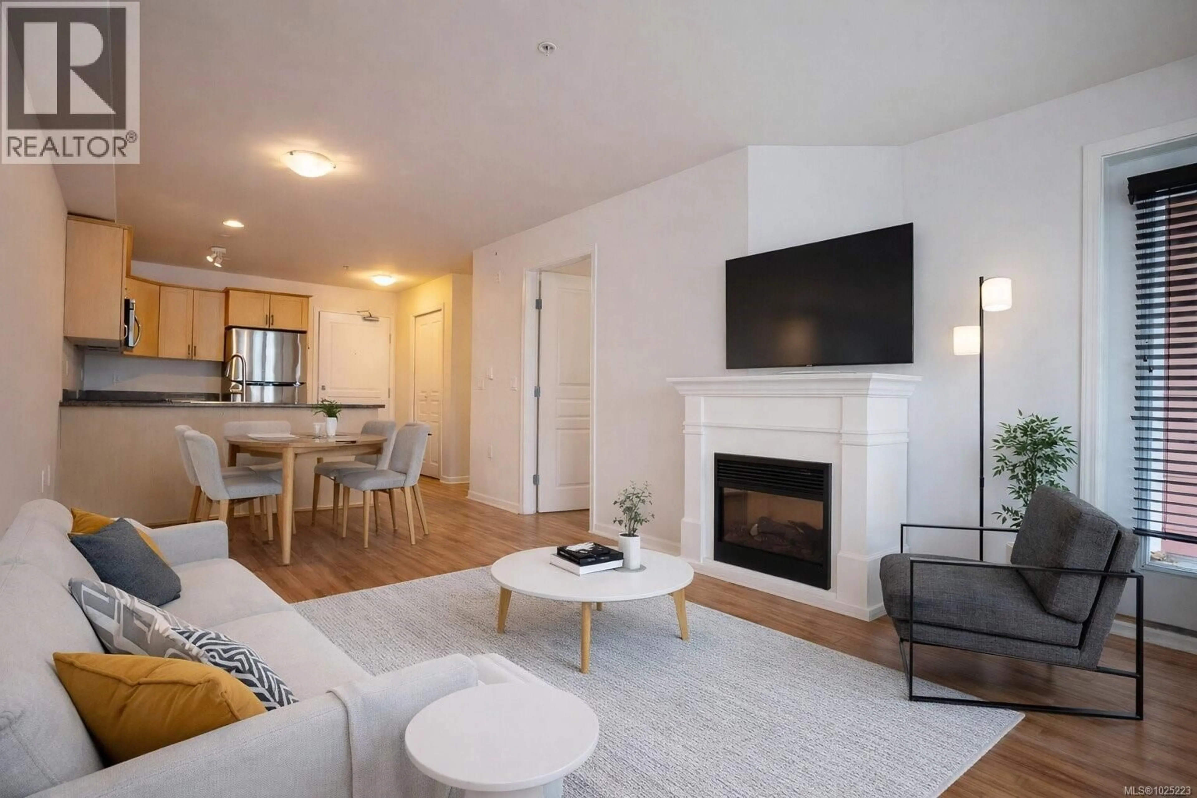 Living room with furniture, wood/laminate floor for 210 - 655 GOLDSTREAM AVENUE, Langford British Columbia V9B0G2