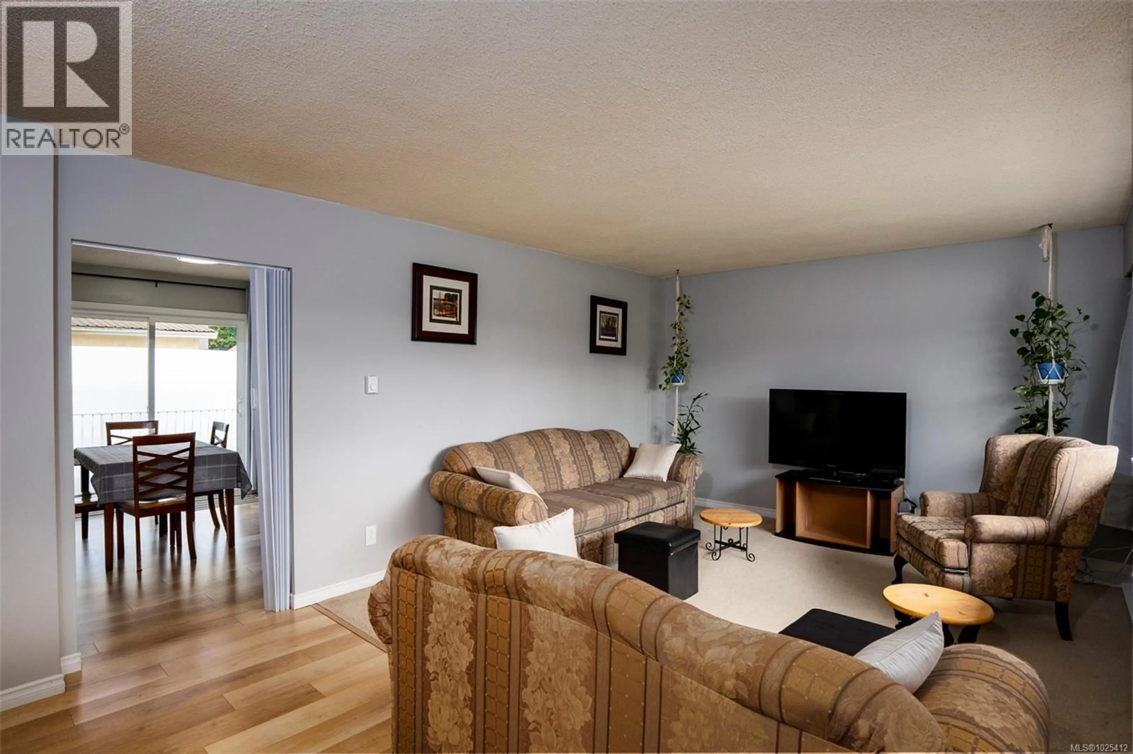 Living room with furniture, wood/laminate floor for 2116 NORTHFIELD ROAD, Nanaimo British Columbia V9S3B9