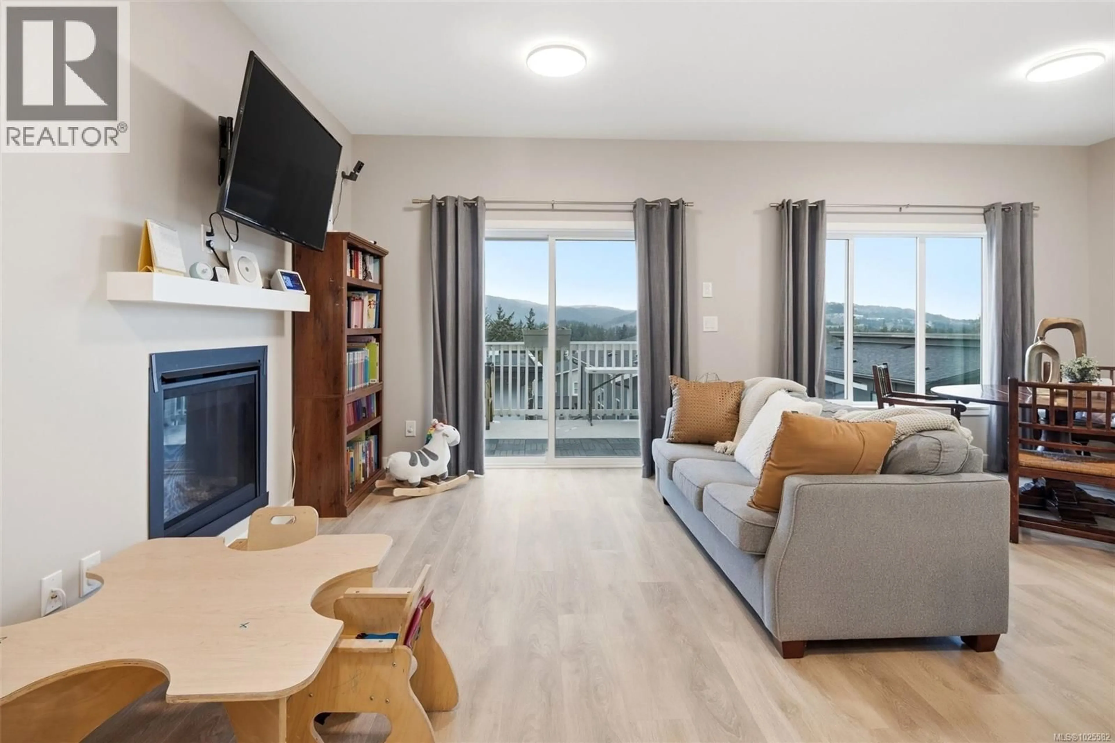 Living room with furniture, wood/laminate floor for 3481 MYLES MANSELL ROAD, Langford British Columbia V9C0N6