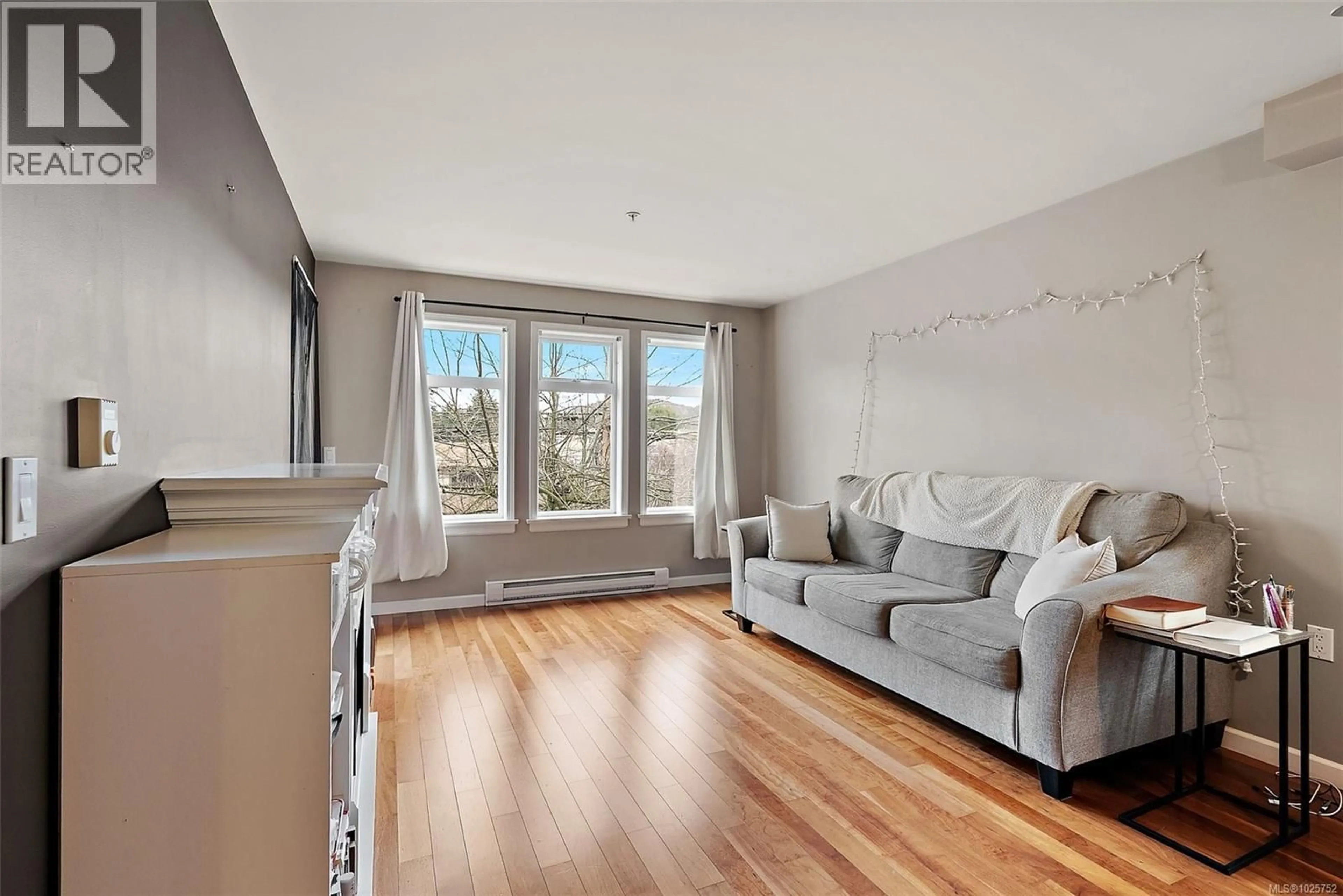 Living room with furniture, wood/laminate floor for 306 - 655 GOLDSTREAM AVENUE, Langford British Columbia V9B0G2